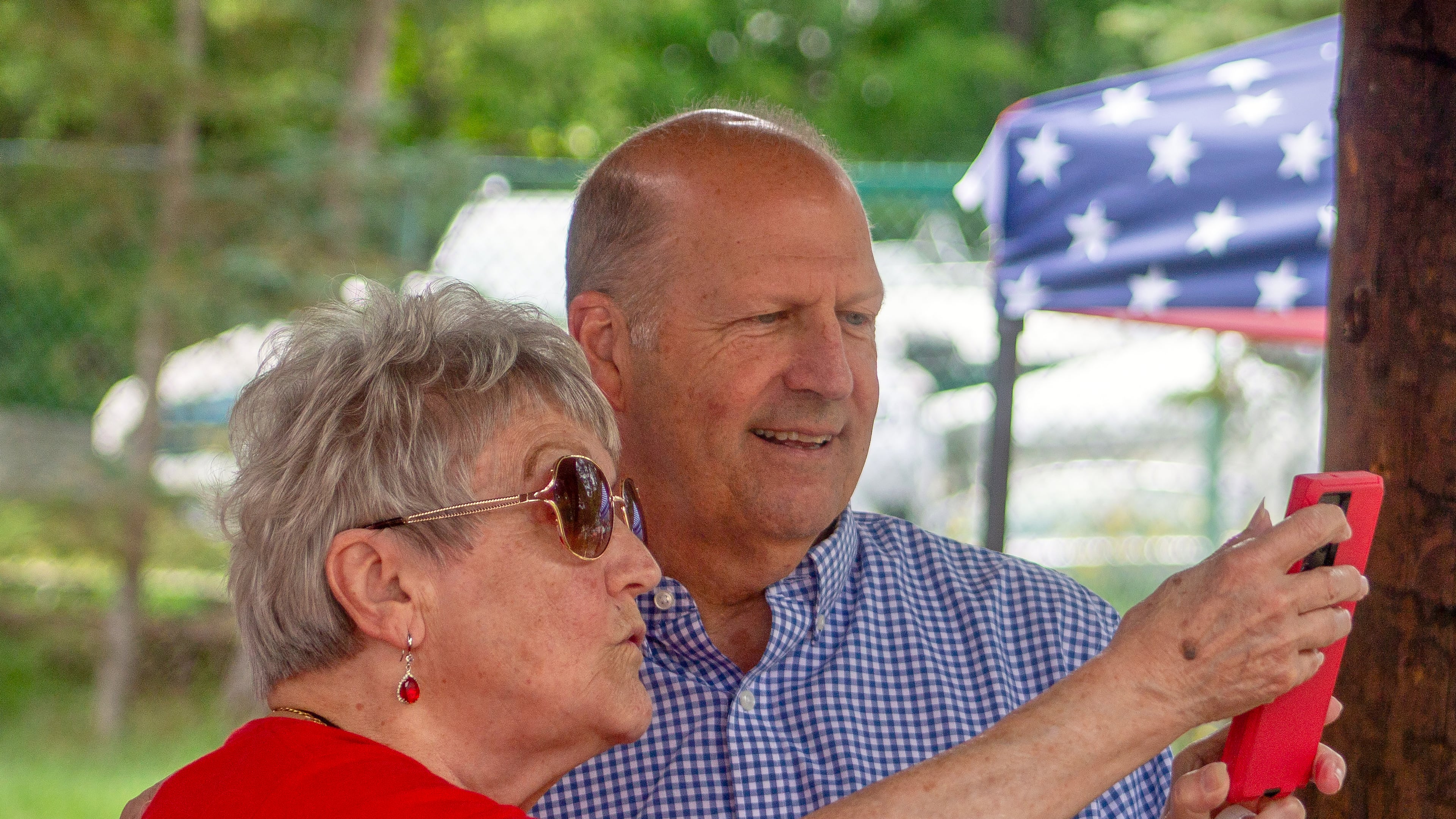 Former Sen. John E. Sununu, who is seeking the GOP nomination for his old seat, takes a selfie with supporter Sudie Francouer, in Berlin, N.H., Saturday, Aug. 22, 2026. (AP Photo/Holly Ramer)