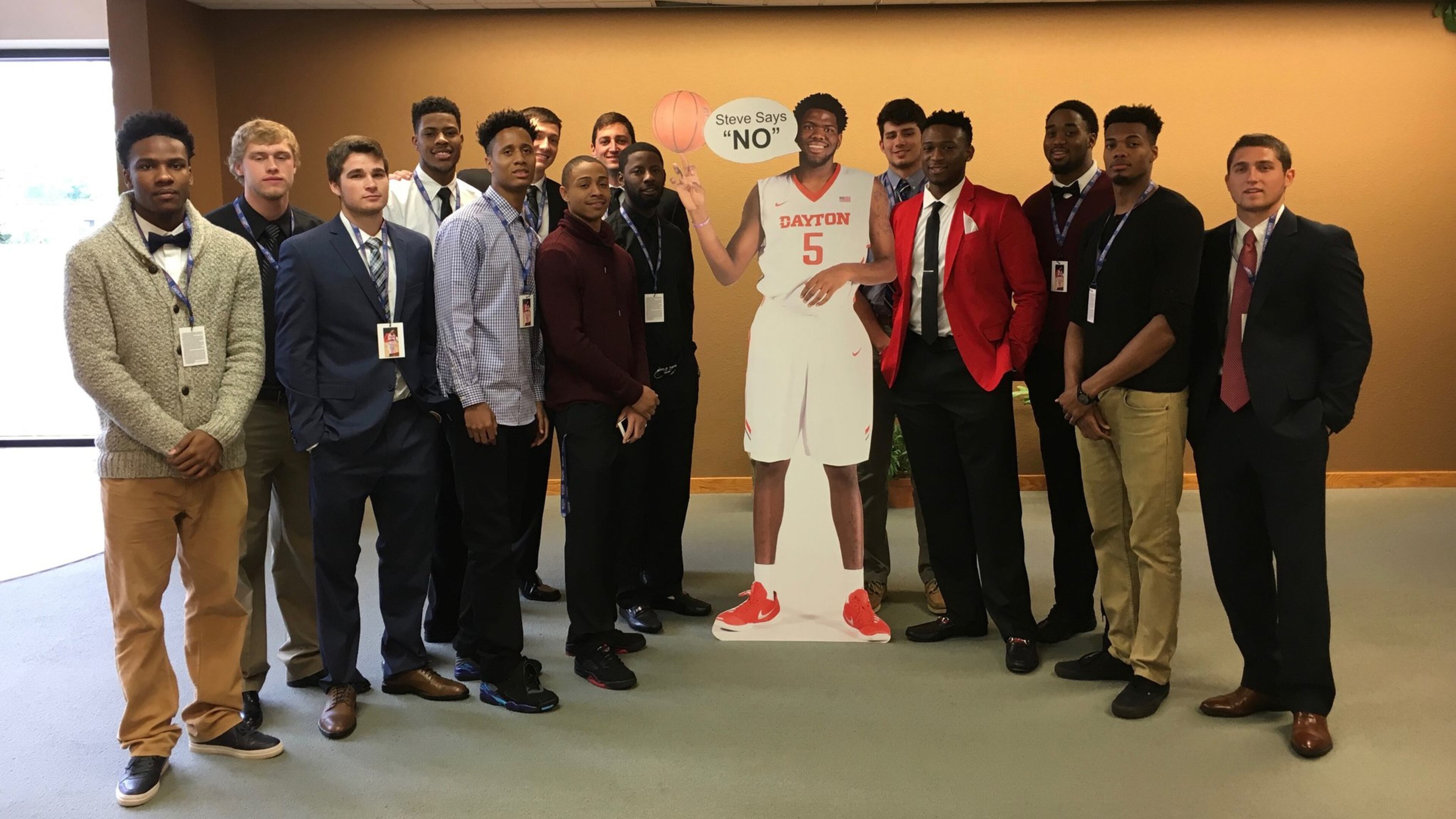 Dayton men’s basketball players pose with a cardboard cutout of Steve McElvene before McElvene’s funeral on Saturday, May 21, 2016, at Abundant Life Church in Fort Wayne, Ind. David Jablonski/Staff