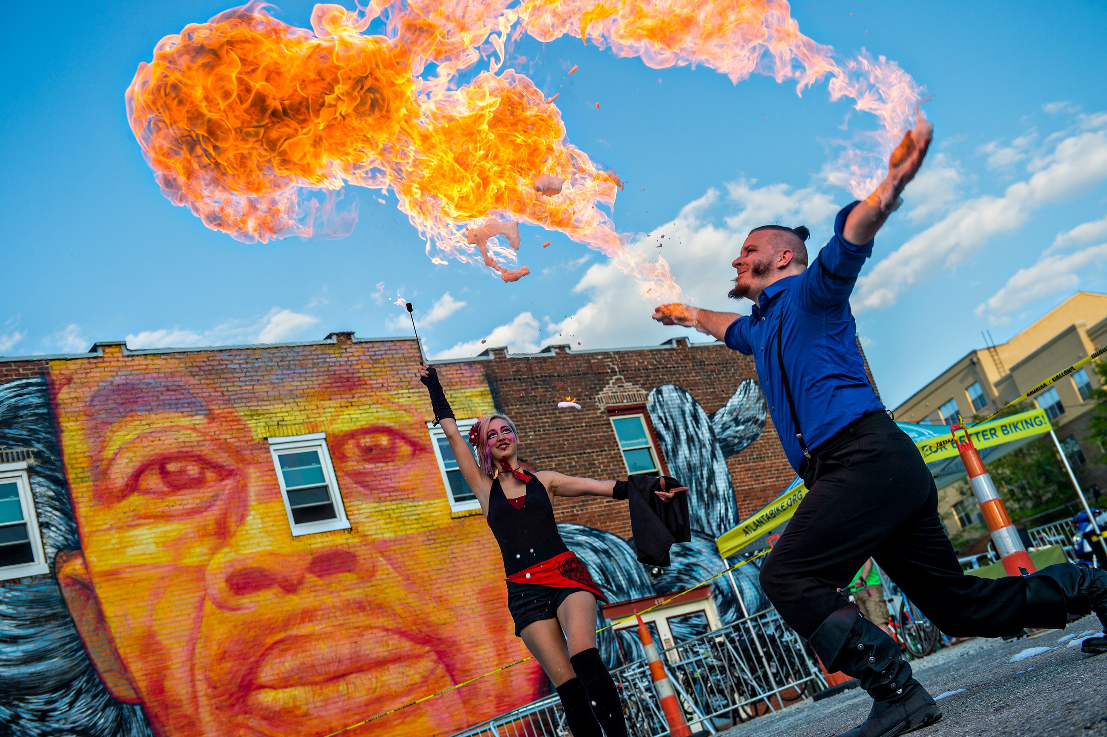 Cosmo Franz (right) and Charlotte Dillard perform with fire during the Fire in the Fourth Festival in the Old Fourth Ward neighborhood of Atlanta on Saturday, May 2, 2015. The first annual festival featured a live musical and fire performances, firefighter muster relays, and aerial acrobatics by the Imperial Opa Circus. JONATHAN PHILLIPS / SPECIAL