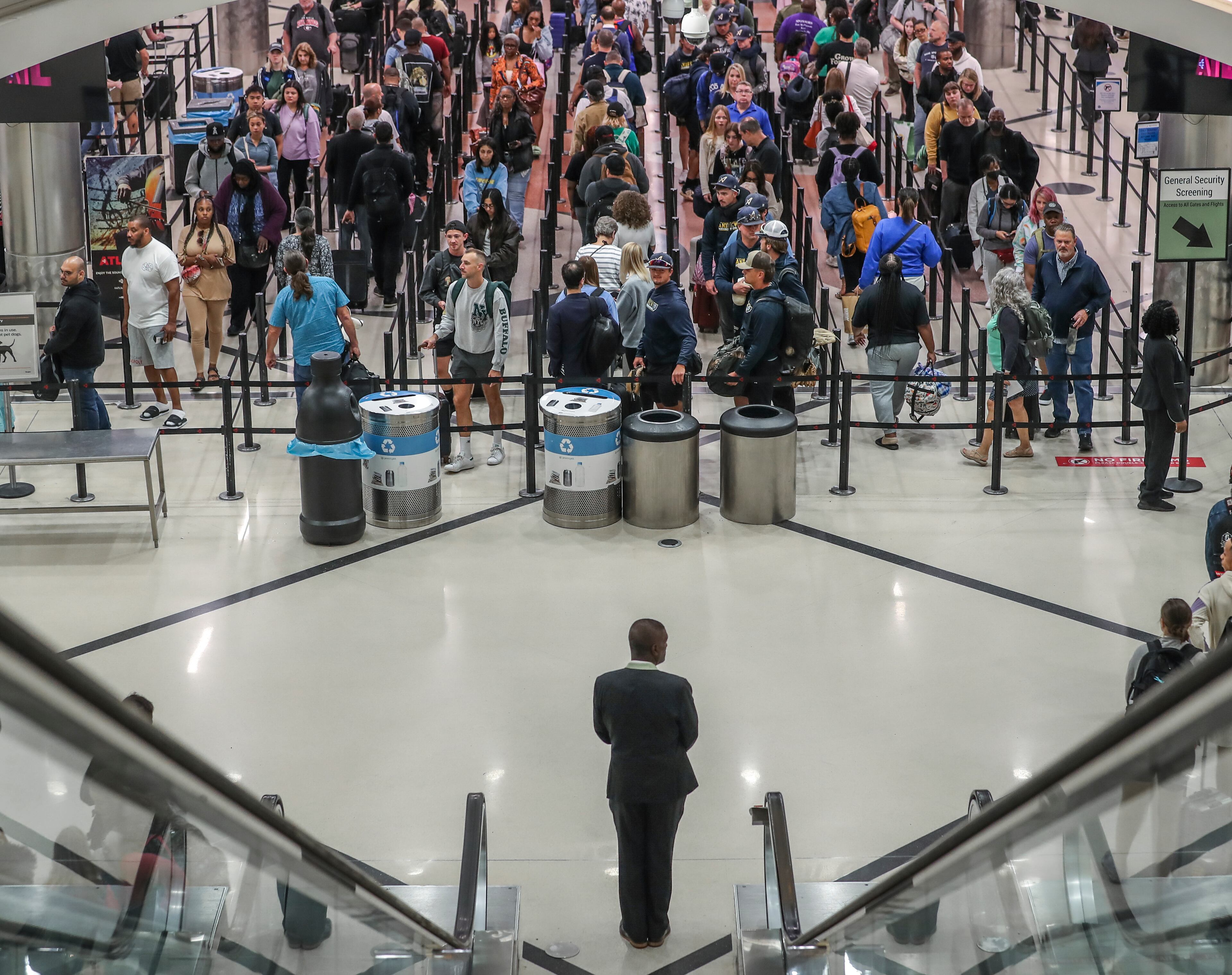 May 25, 2023 Hartsfield-Jackson International Airport: Here travelers surge at the main security checkpoint inside the airport Thursday morning, May 25, 2023 where Large crowds are expected to pass through Hartsfield-Jackson International Airport throughout the Memorial Day weekend. (John Spink / John.Spink@ajc.com)