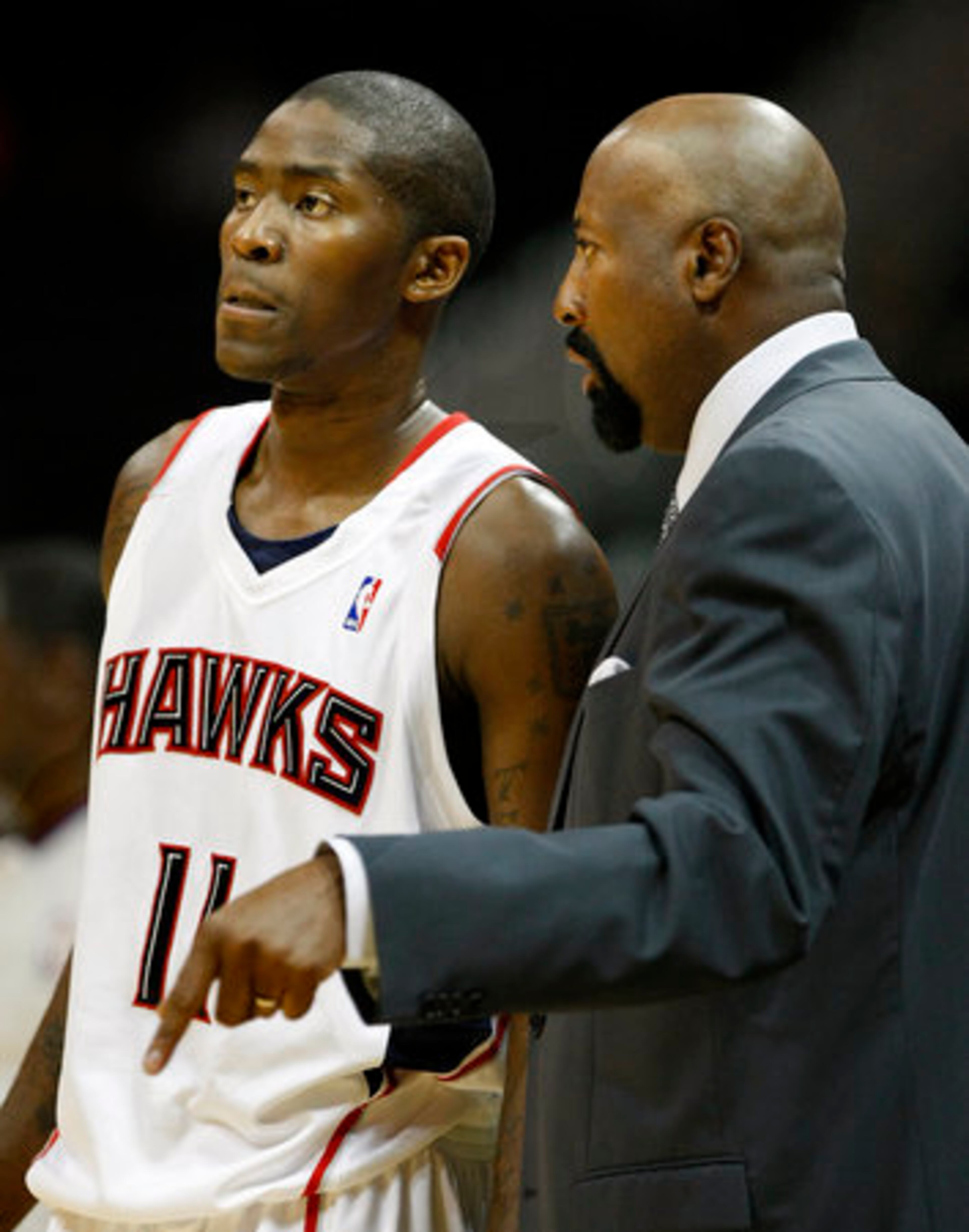 Coach Mike Woodson talks with new Hawk Jamal Crawford during the exhibition opener at Philips Arena Wednesday night.
