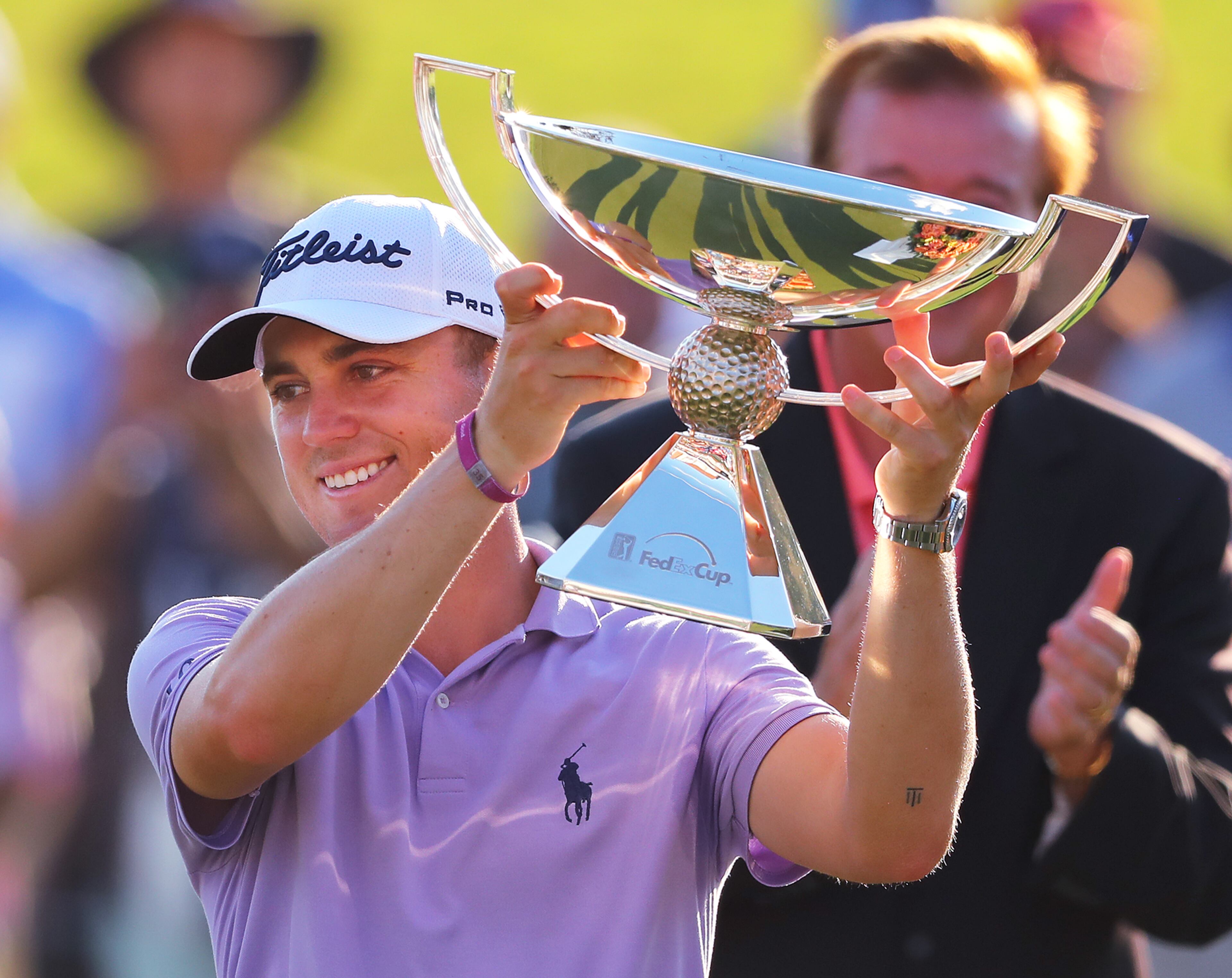 Justin Thomas is presented the FedEx Cup on the 18th green at the conclusion of the Tour Championship at East Lake Golf Club on Sunday, September 24, 2017, in Atlanta. Curtis Compton/ccompton@ajc.com