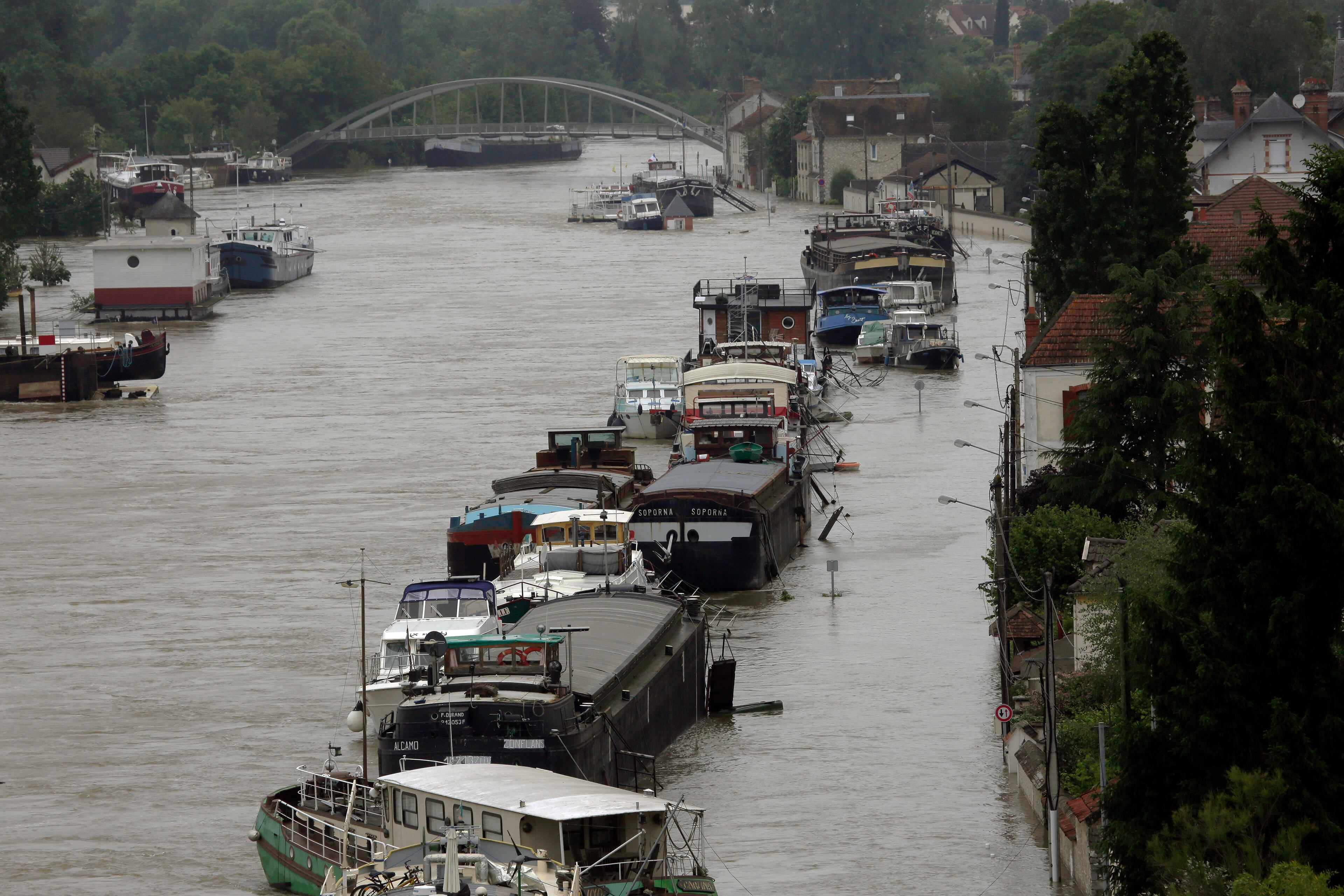 Boats are lined up on the flooded Loing Canal in St Mammes, where the Loing joins the Seine south of Paris, France, Thursday June 2, 2016. Floods inundating parts of France and Germany have left five people dead and thousands trapped in homes or cars, as rivers have broken their banks from Paris to Bavaria.(AP Photo/Jerome Delay)