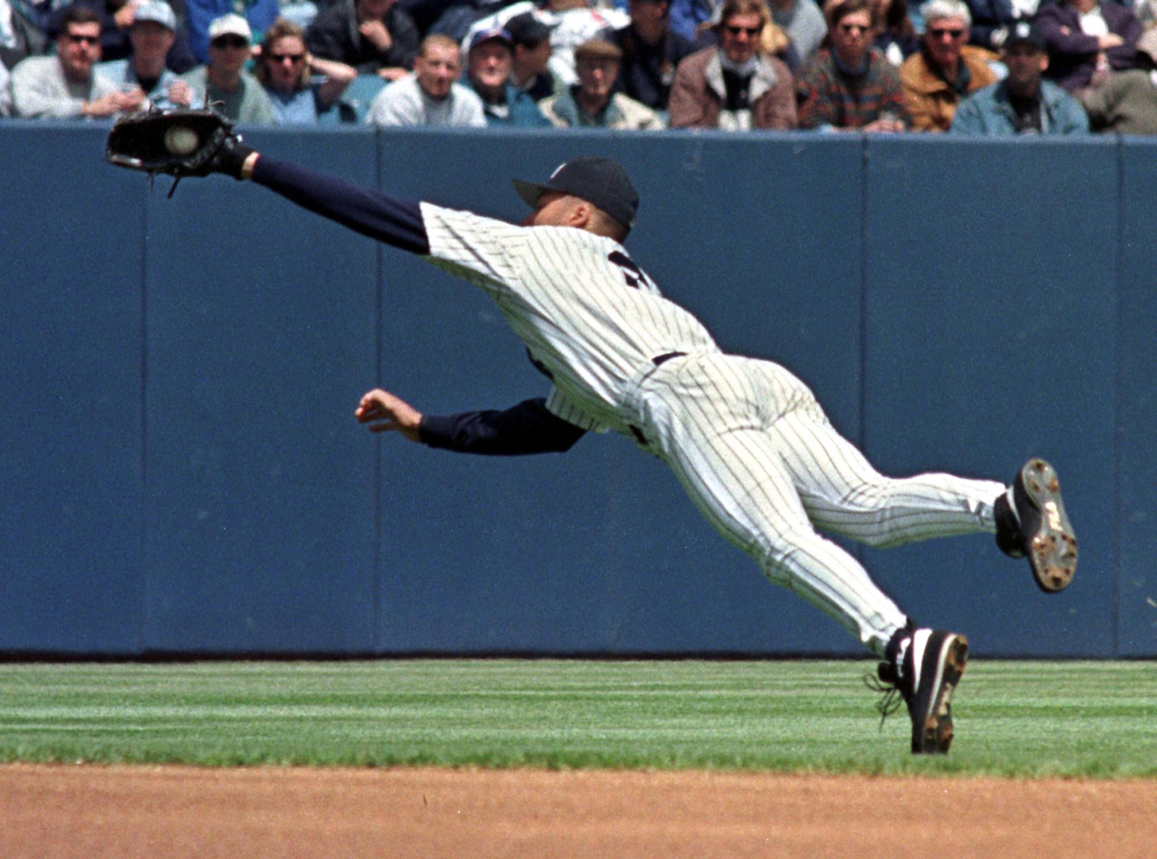 NEW YORK, UNITED STATES: New York Yankees shortstop Derek Jeter leaps to his right to catch a line drive off the bat of Boston Red Sox player Darren Bragg in the first inning their 22 May game at Yankee Stadium. The Red Sox beat the Yankees 8-2. AFP PHOTO/HENNY RAY ABRAMS (Photo credit should read HENNY RAY ABRAMS/AFP/Getty Images)