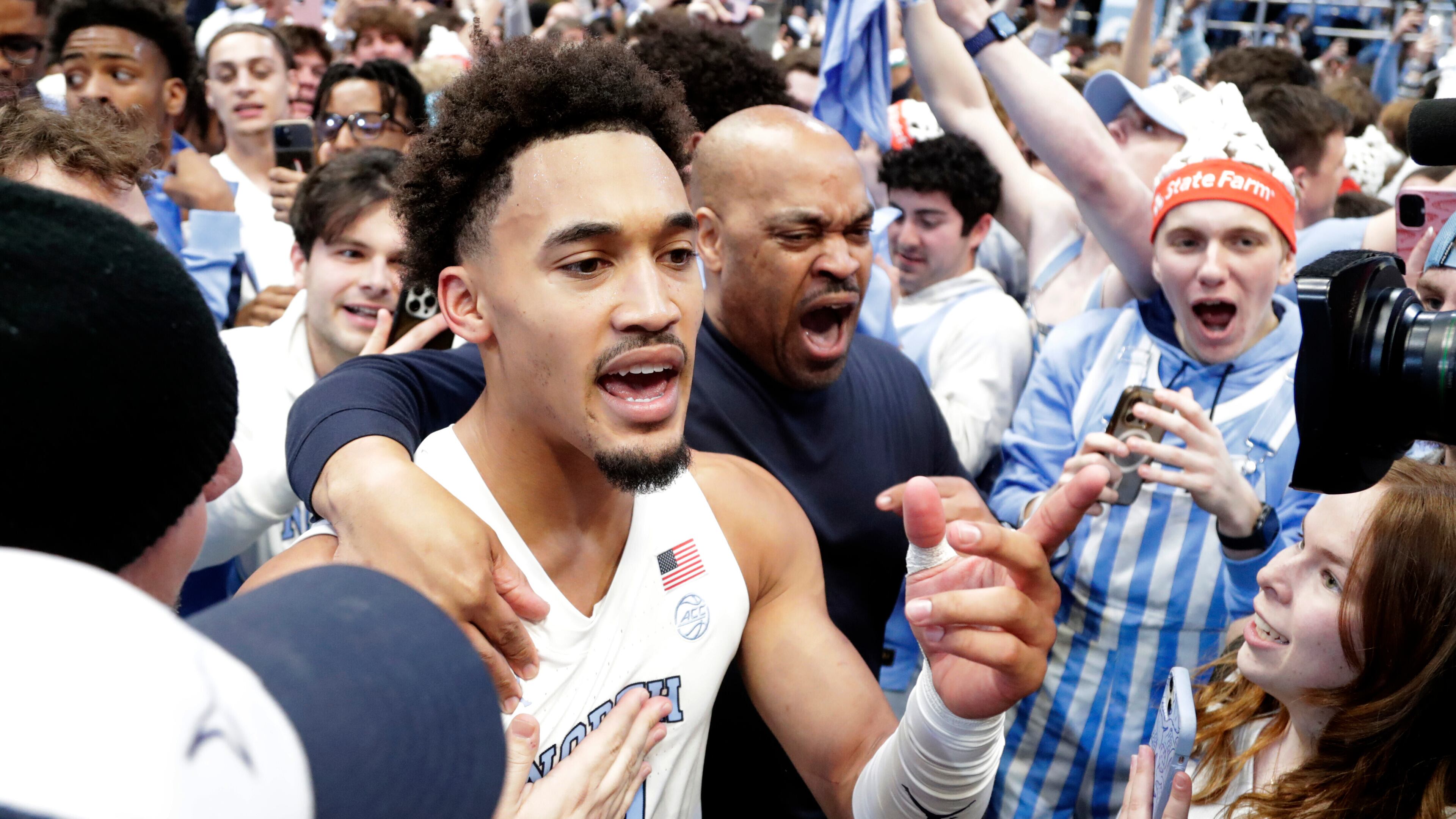 North Carolina guard Seth Trimble (7) celebrates with fans after an NCAA college basketball game against Duke, Saturday, Feb. 7, 2026, in Chapel Hill, N.C. (AP Photo/Chris Seward)