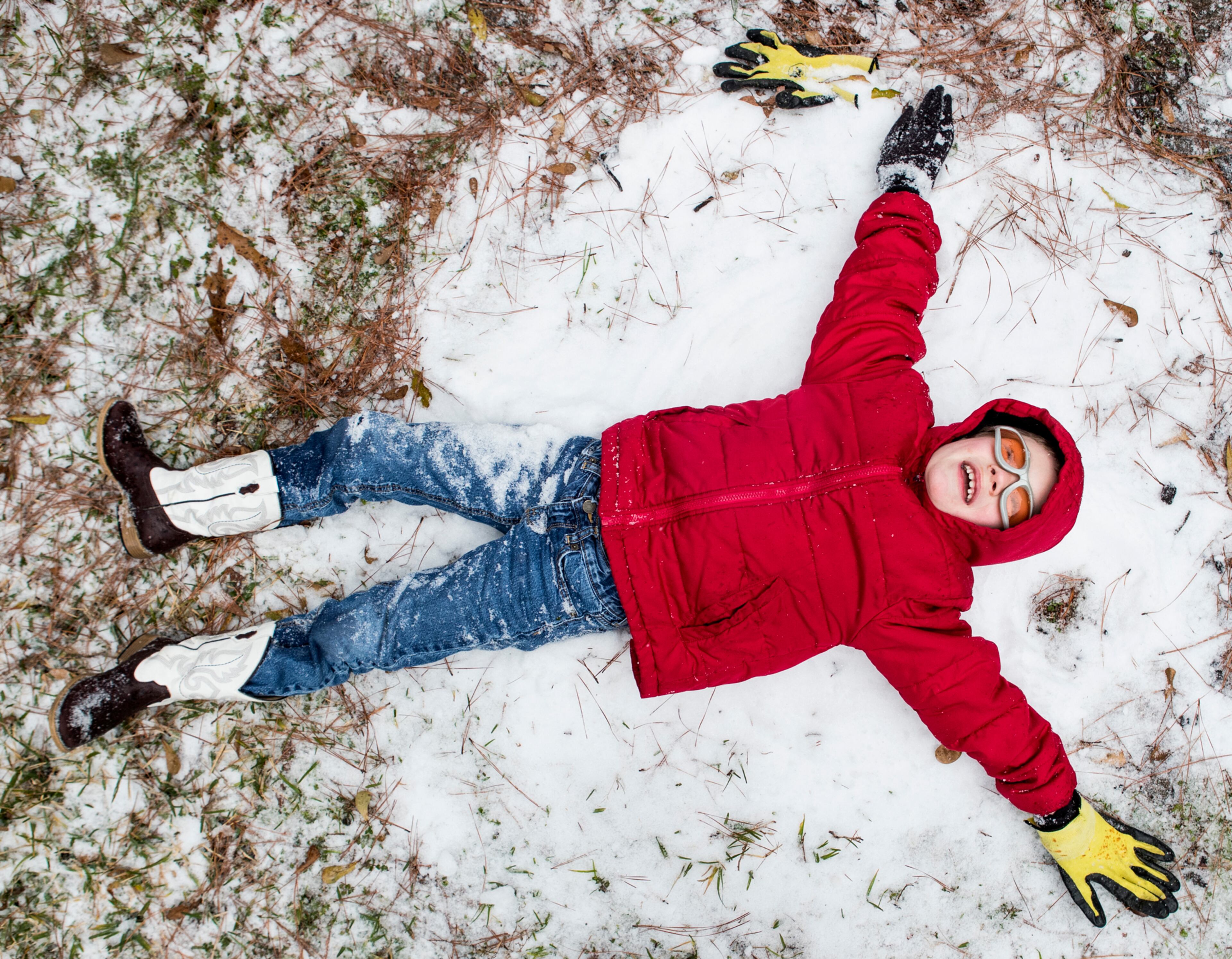 Zach Arnold tries to make a snow angel while playing in the snow on Tuesday, Jan. 16, 2018, in Spring, Texas. Winter weather turned travel treacherous across the South, shutting down interstates in Louisiana, causing highway crashes in Kentucky and closing airport runways in Texas as snow turned the red clay white and prompted schools to close across the region.