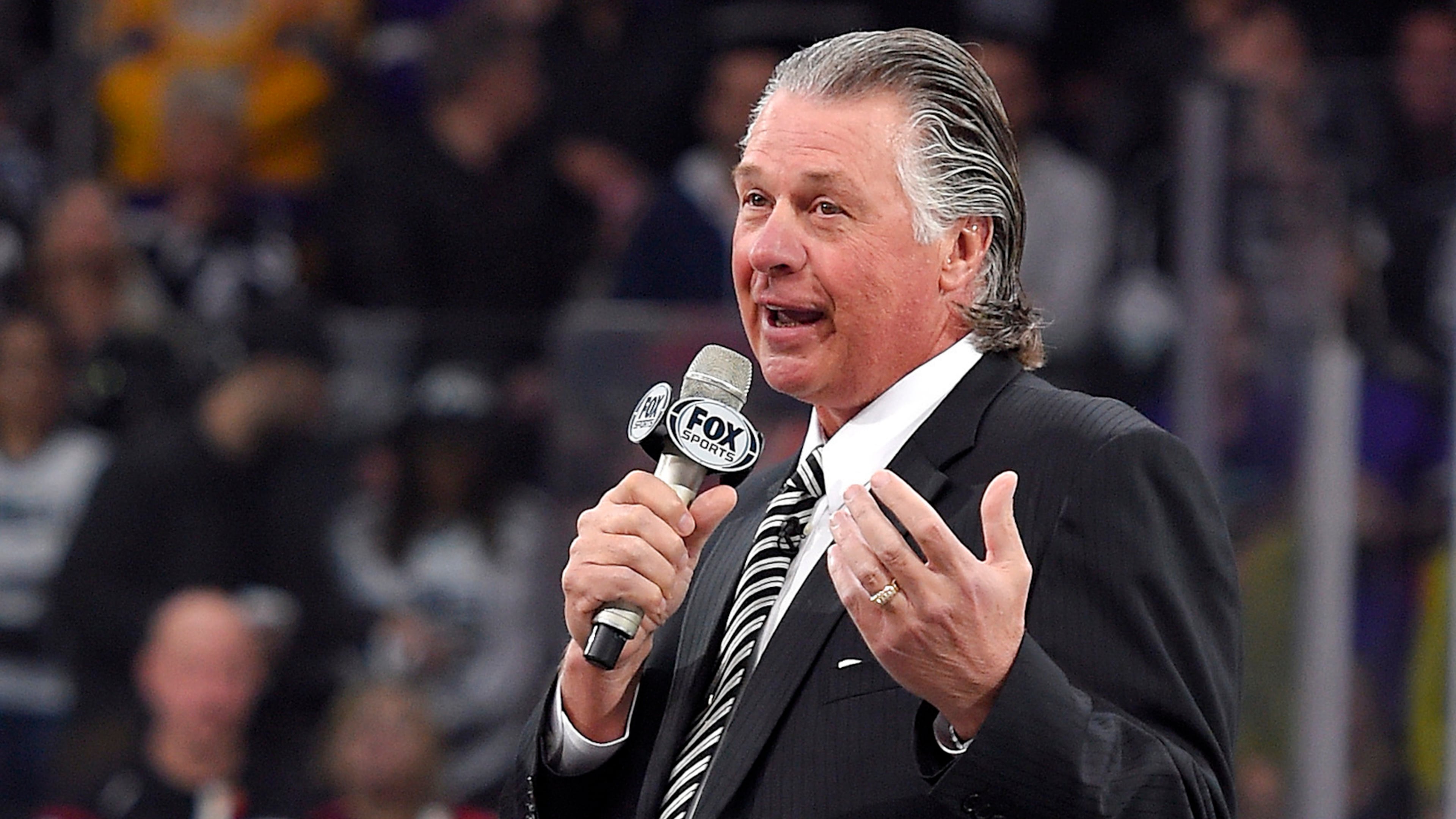 FILE - Former Los Angeles Kings coach Barry Melrose speaks to fans as he is honored prior to an NHL hockey game between the Kings and the Calgary Flames, on Feb. 12, 2015, in Los Angeles. (AP Photo/Mark J. Terrill, File)