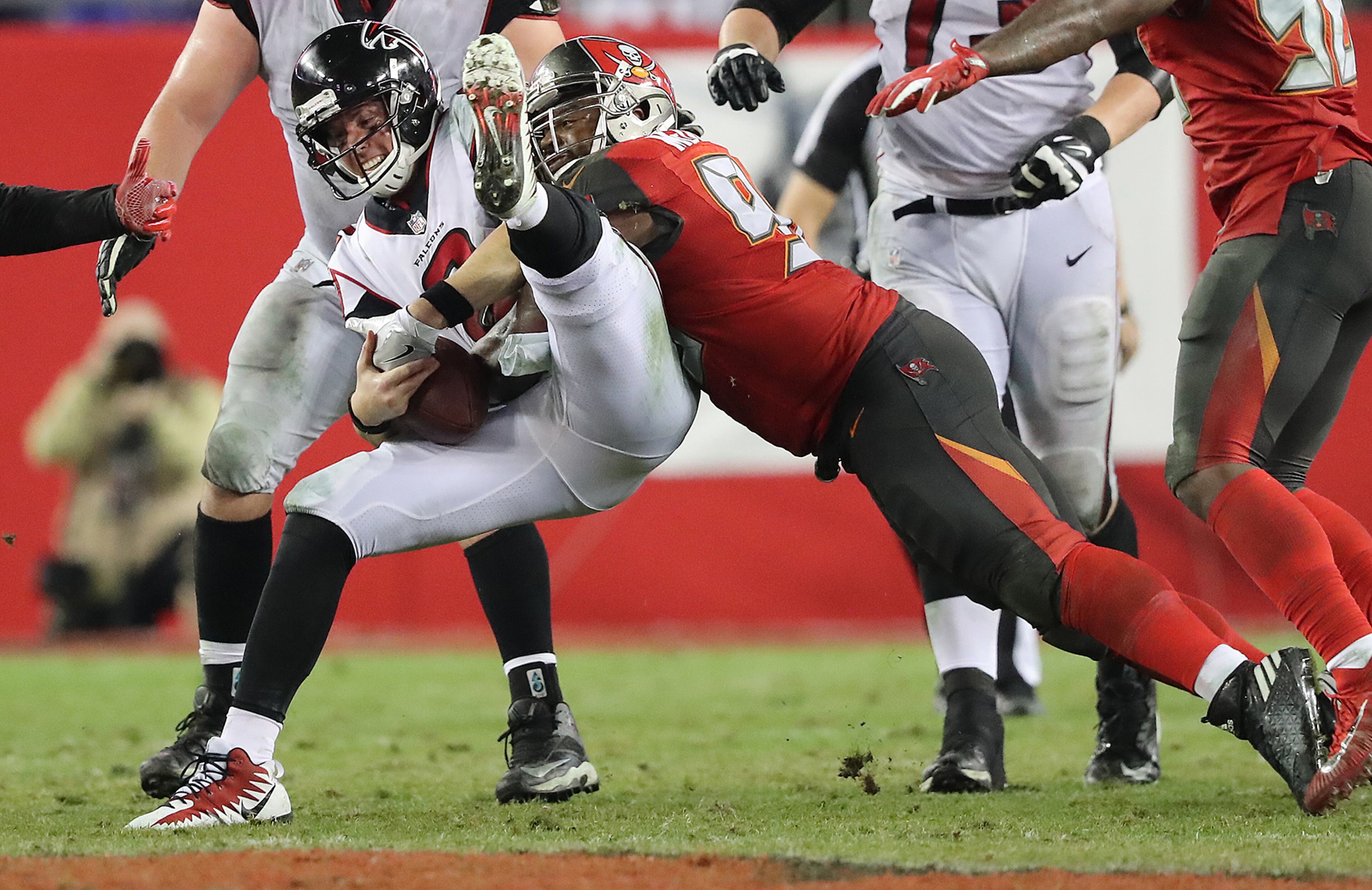 December 18, 2017 Tampa: Falcons quarterback Matt Ryan barely holds on to the football on a sack by Buccaneers Clinton McDonald during a third down play in the final minutes of a NFL football game on Monday, December 18, 2017, in Tampa. The Falcons held on to beat the Bucs 24-21. Curtis Compton/ccompton@ajc.com