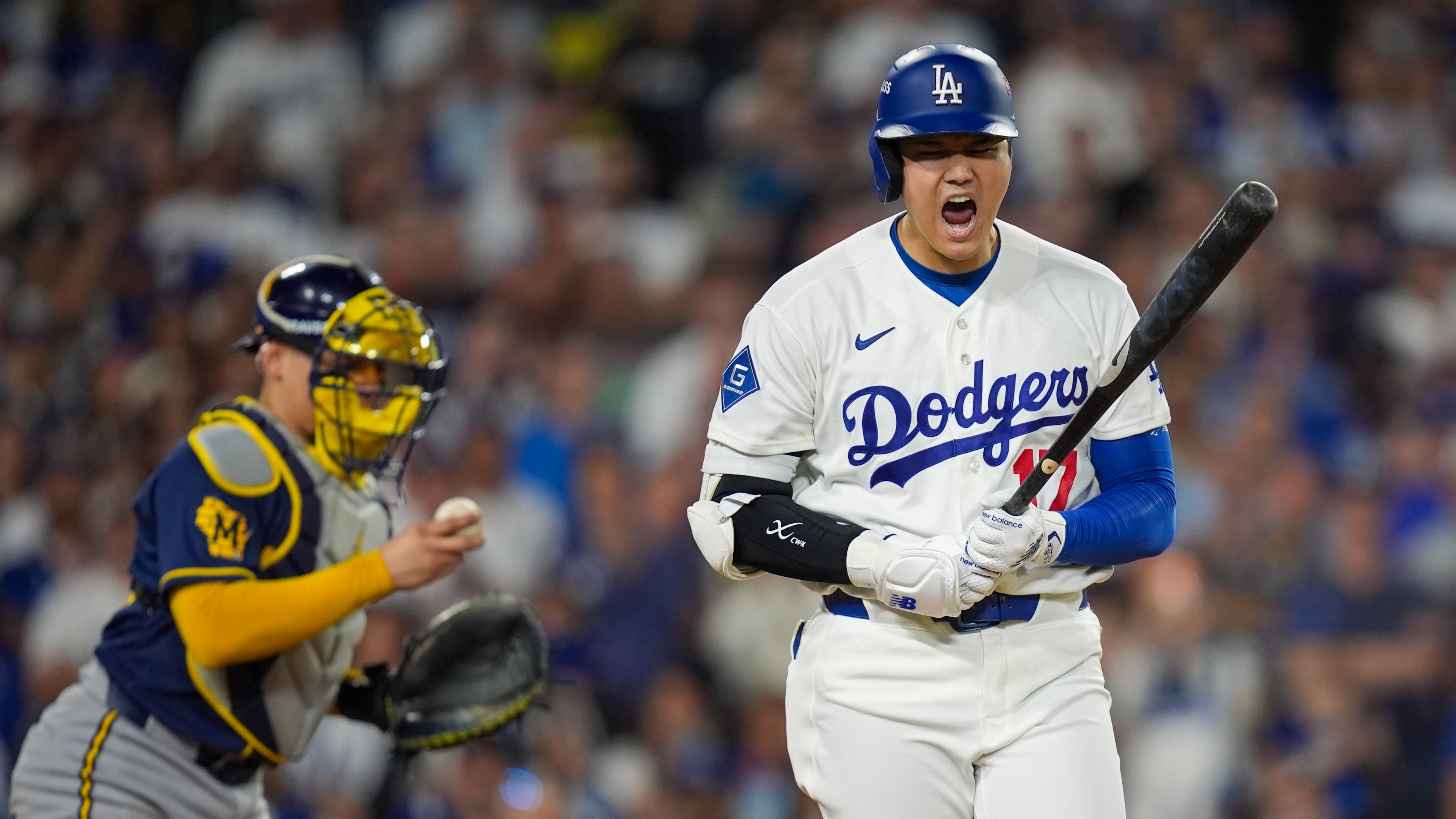 Los Angeles Dodgers designated hitter Shohei Ohtani reacts to being walked during the sixth inning of Game 3 of baseball's National League Championship Series between the Milwaukee Brewers and the Los Angeles Dodgers, Wednesday, Oct. 14, 2026, in Los Angeles. (AP Photo/Gregory Bull)