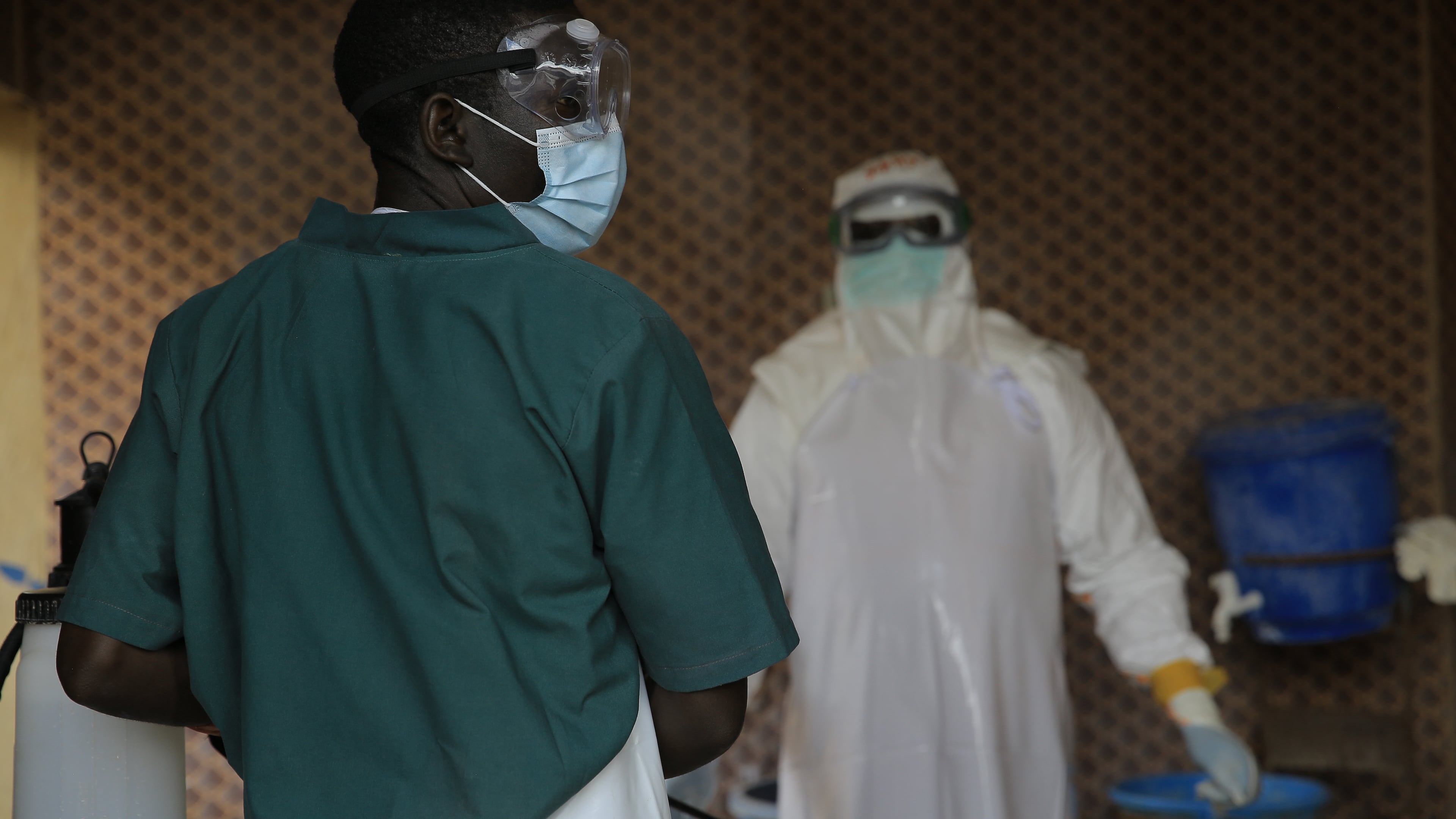 A healthcare worker is disinfected by his colleague inside a treatment center for Ebola patients in Beni, North Kivu province, eastern Congo, Saturday, Sept. 26, 2026. (AP Photo/Sebastien Kitsa Musayi)