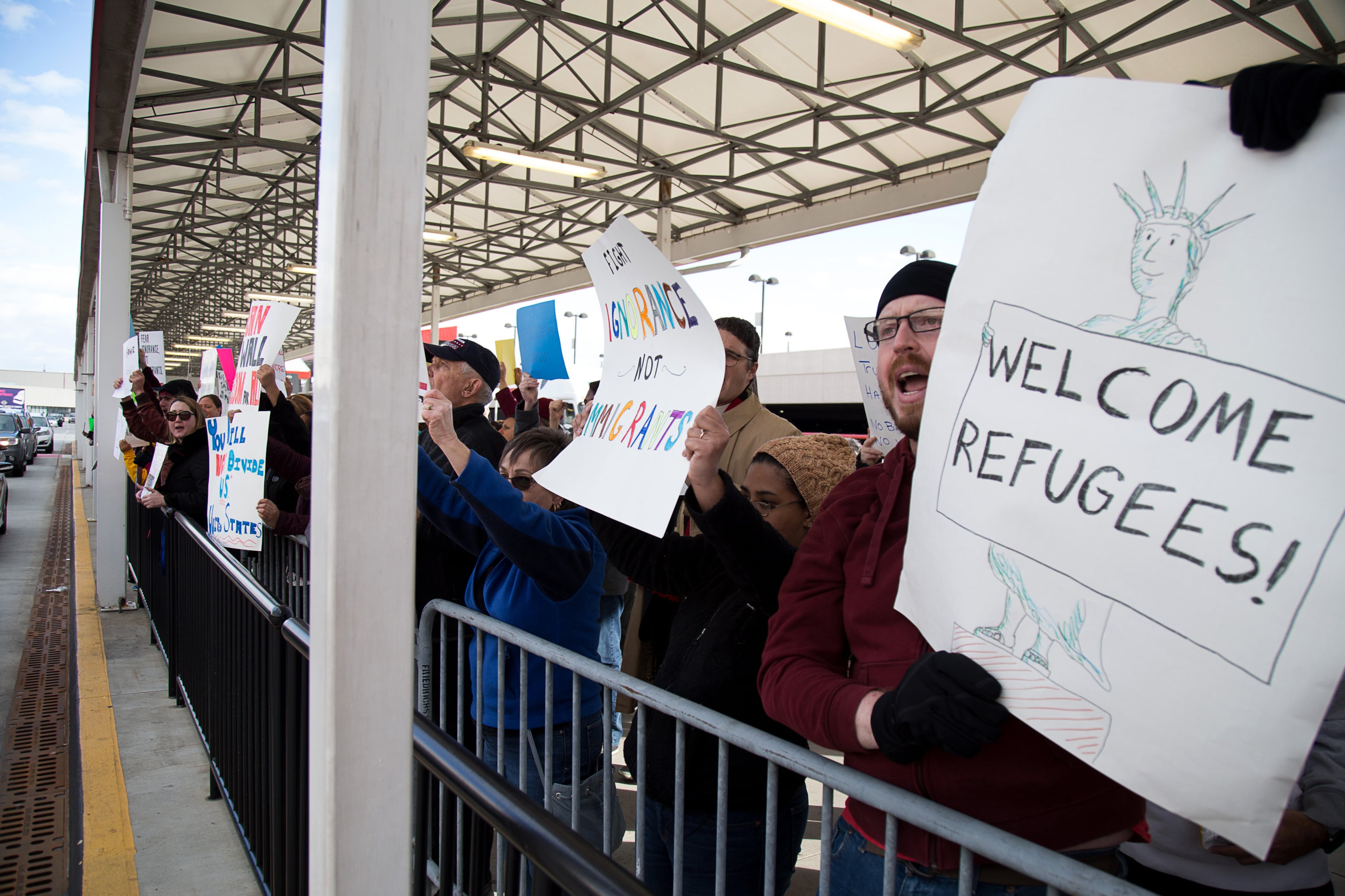 Protesters chant and hold up signs in opposition to President Trump's recent travel ban Sunday at Hartsfield-Jackson Atlanta International Airport January 30, 2017. STEVE SCHAEFER / SPECIAL TO THE AJC