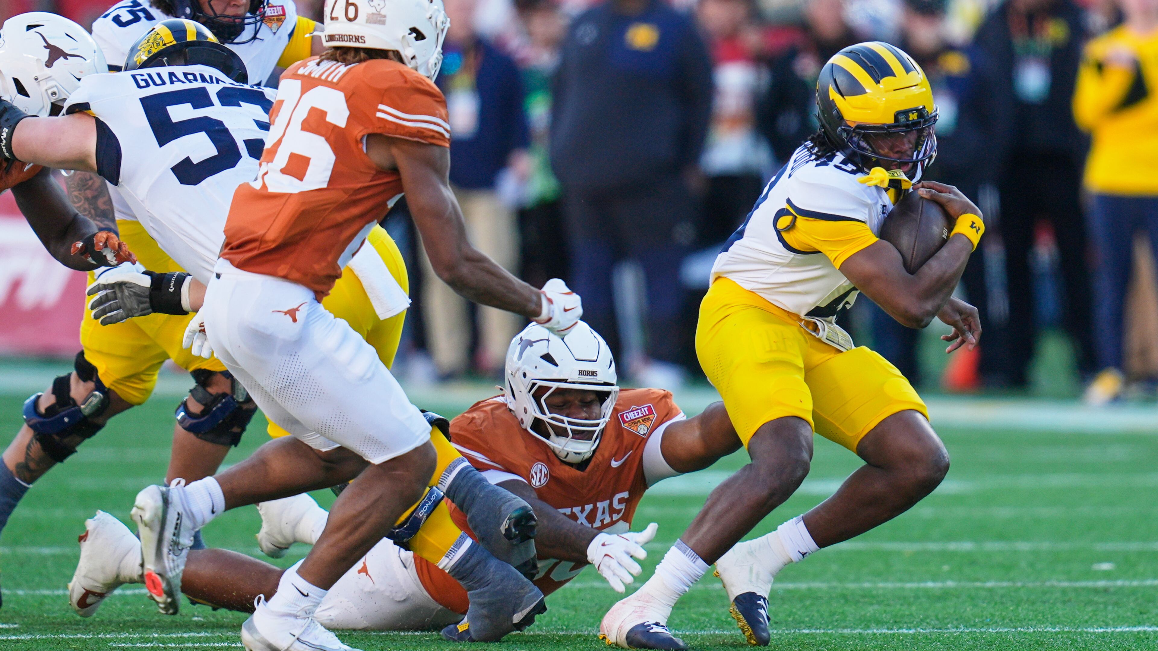 Texas and Michigan would have benefitted from a 24-team CFP field last season. Instead, the traditional powerhouses met in the Citrus Bowl in a game the Longhorns won by a 41-27 count. (John Raoux/AP)
