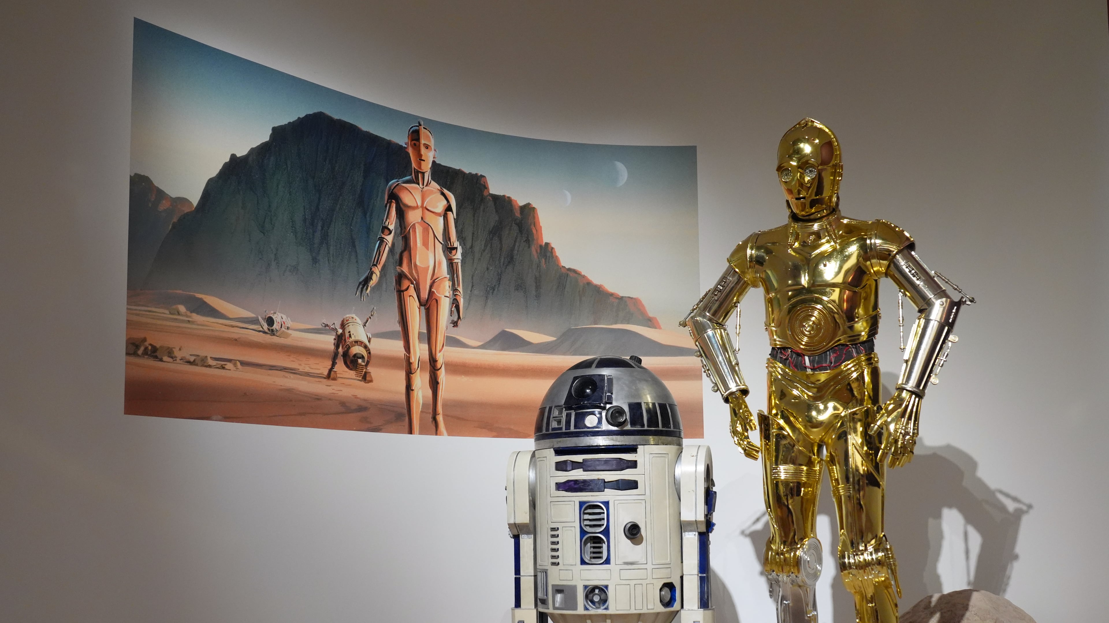 Production designer Norman Reynolds' robot R2-D2, left, and John Mollo's costume for the C-3PO character from the "Star Wars" franchise are displayed in the Cinema Gallery during a preview of the Lucas Museum of Narrative Art on Monday, Aug. 31, 2026, in Los Angeles. (AP Photo/Chris Pizzello)