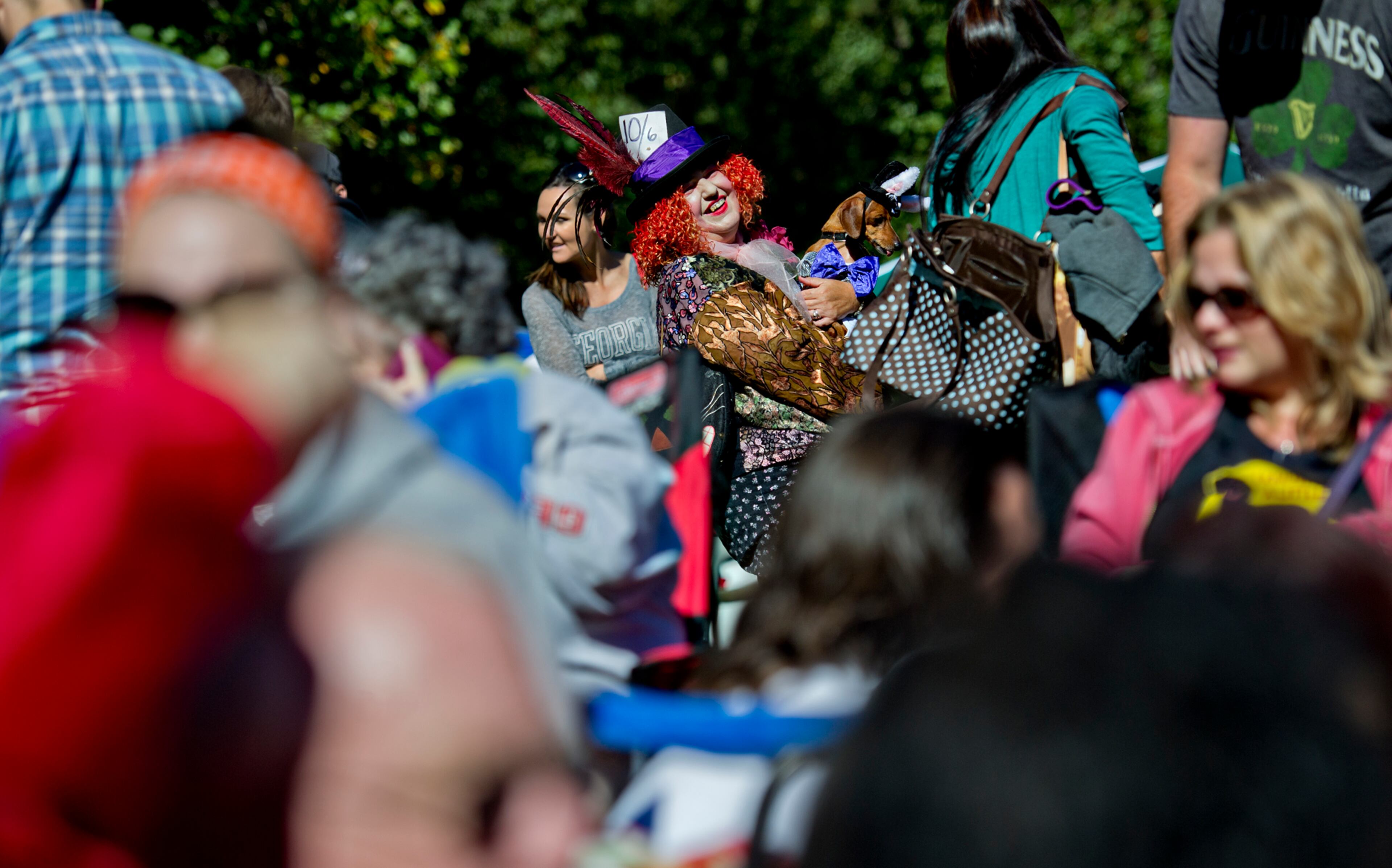 Emma Waters (center) holds her dachshund Penny as they wait for the start of the costume contest during Howl-O-Weenie at Liane Levetan Park at Brook Run in Dunwoody on Saturday, October 4, 2014. The event celebrated everything dachshund with howling, kissing and costume contests, hot dogs and other competitions all to benefit DREAM Dachshund Rescue.