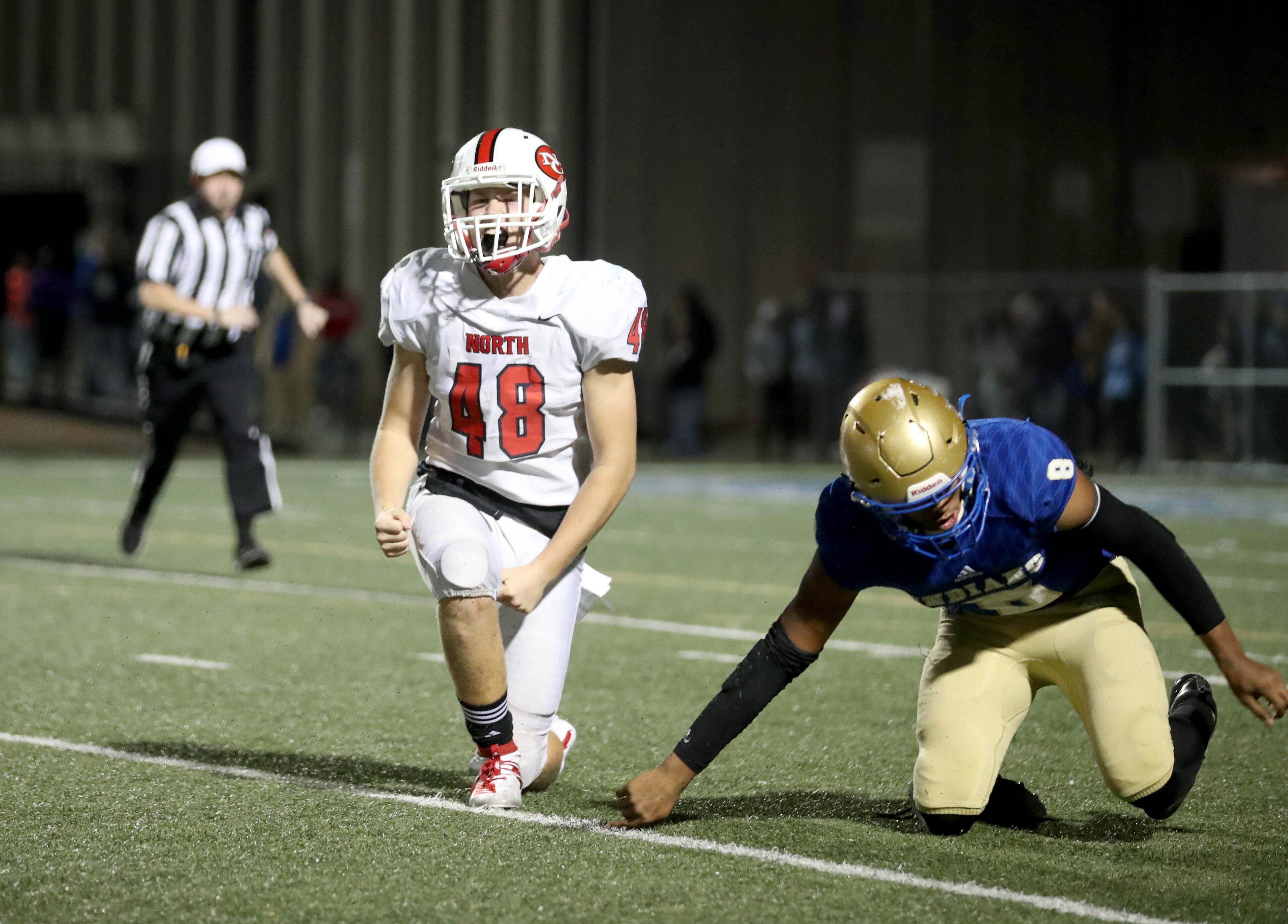 North Gwinnett linebacker Will Long (48) celebrates after he sacked McEachern quarterback Carlos Del Rio-Wilson (8) in the second half of the Class 7A quarterfinals at McEachern High School Friday, November 29, 2019 in Powder Springs, Ga. North Gwinnett won 32-13. (JASON GETZ/SPECIAL TO THE AJC)