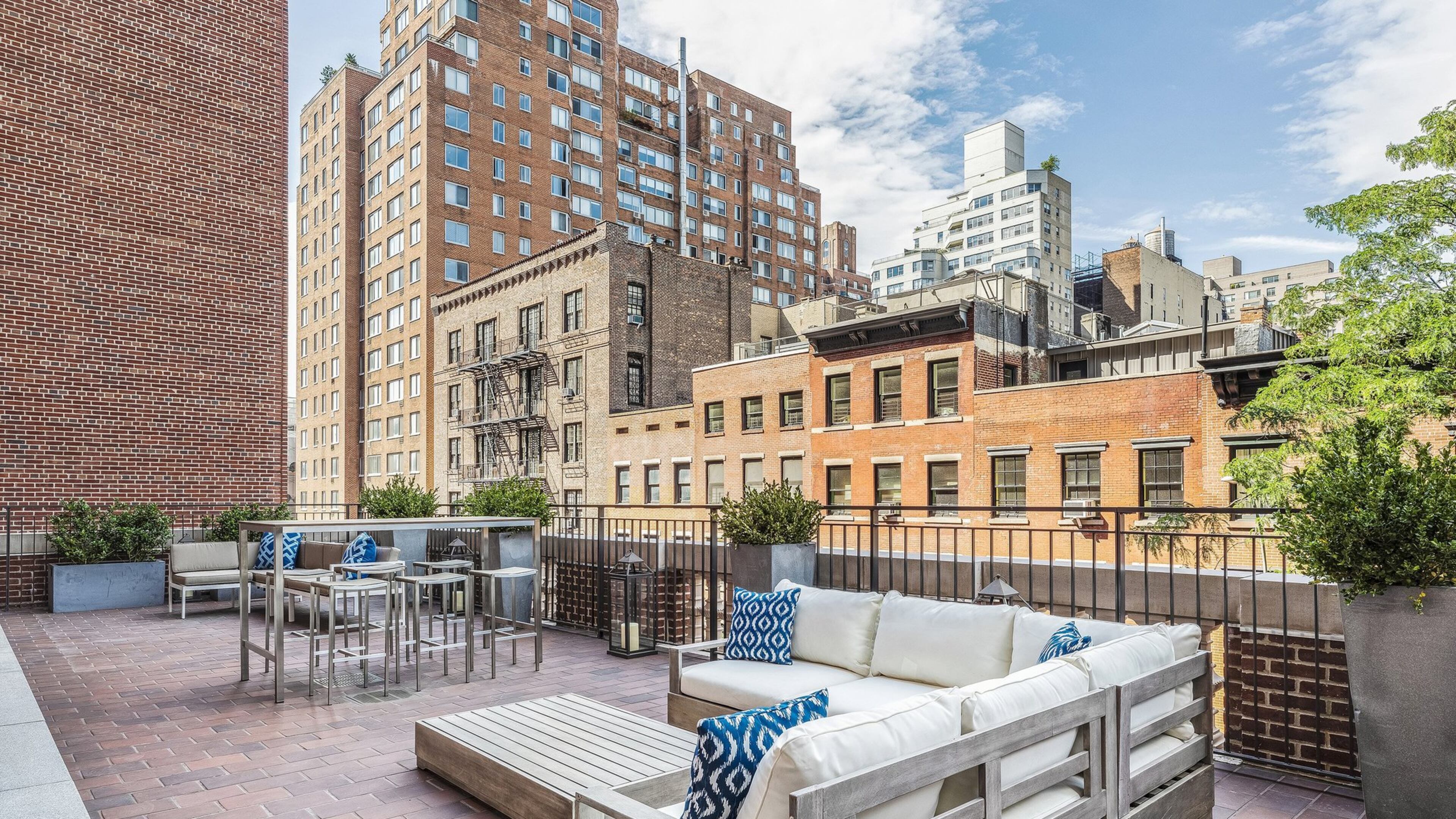 An outdoor space is divided into lounge and dining zones. (Design Recipes)