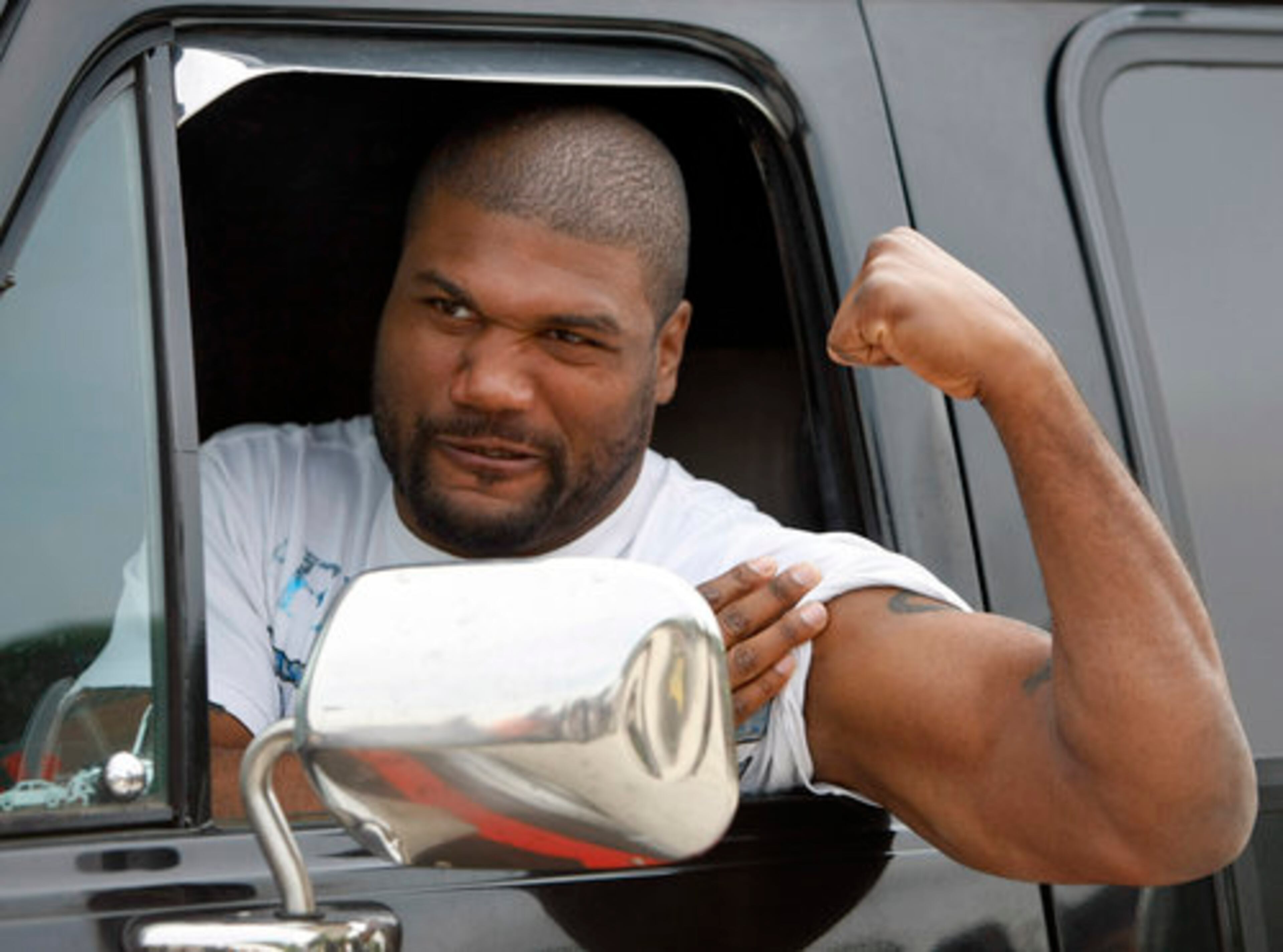 BREAKING OUT THE HEAVY ARTILLERY: Quinton Jackson flexes his biceps during a photocall for "The A-Team" in Paris.