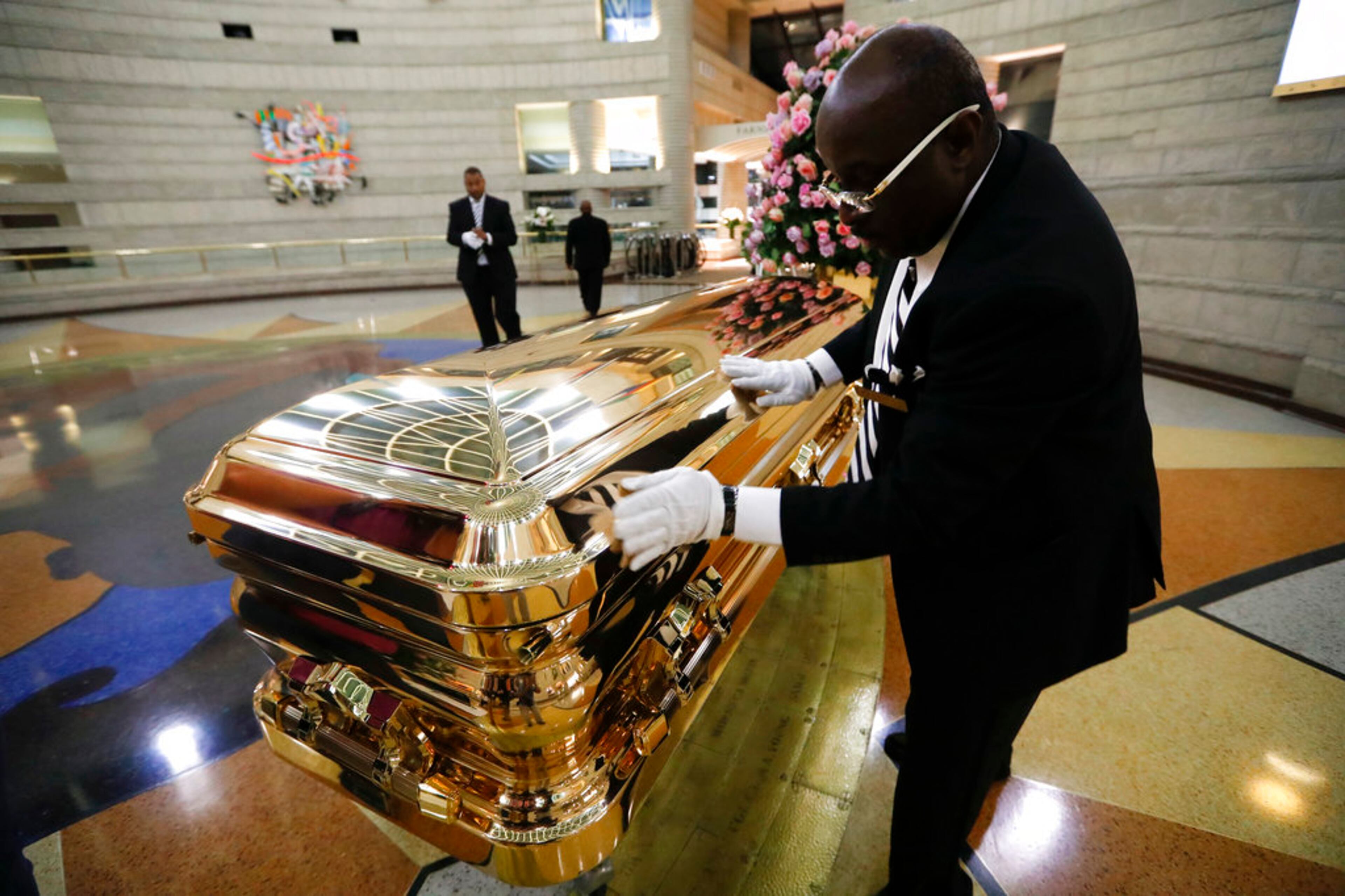 Vincent Street wipes down the casket of legendary singer Aretha Franklin at the Charles H. Wright Museum of African American History in Detroit, Wednesday, Aug. 29, 2018. Franklin died Aug. 16, 2018 of pancreatic cancer at the age of 76. (AP Photo/Paul Sancya)