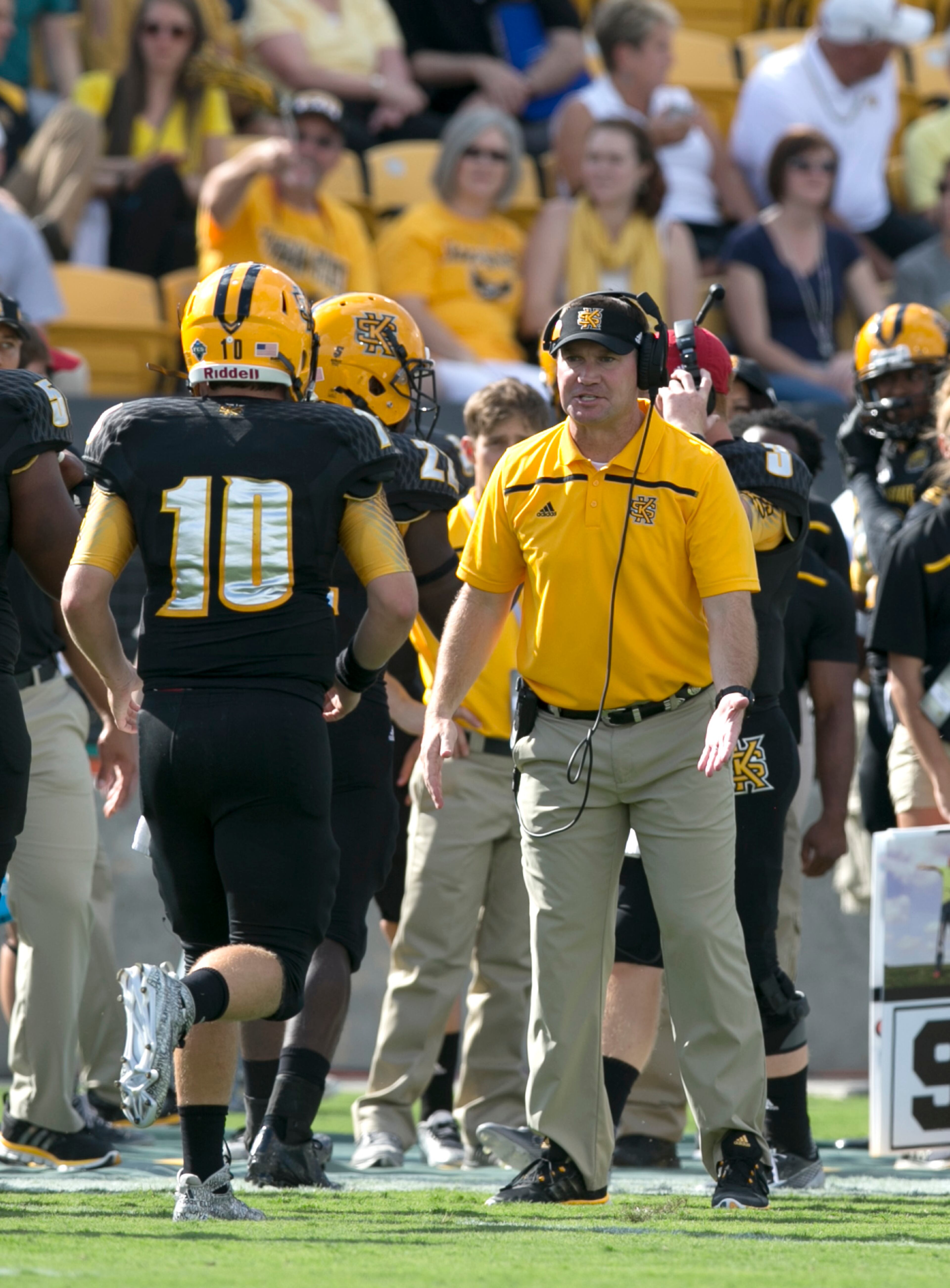 September 12, 2015 - Kennesaw, Ga: Kennesaw State University coach Brian Bohannon, center, congratulates quarterback Trey White (10) after his second rushing touchdown in the first quarter of their game against Edward Waters at Fifth Third Bank Stadium, Saturday, September 12, 2015, in Kennesaw, Ga.. This is the first home game of KSU's inaugural football season. PHOTO / JASON GETZ