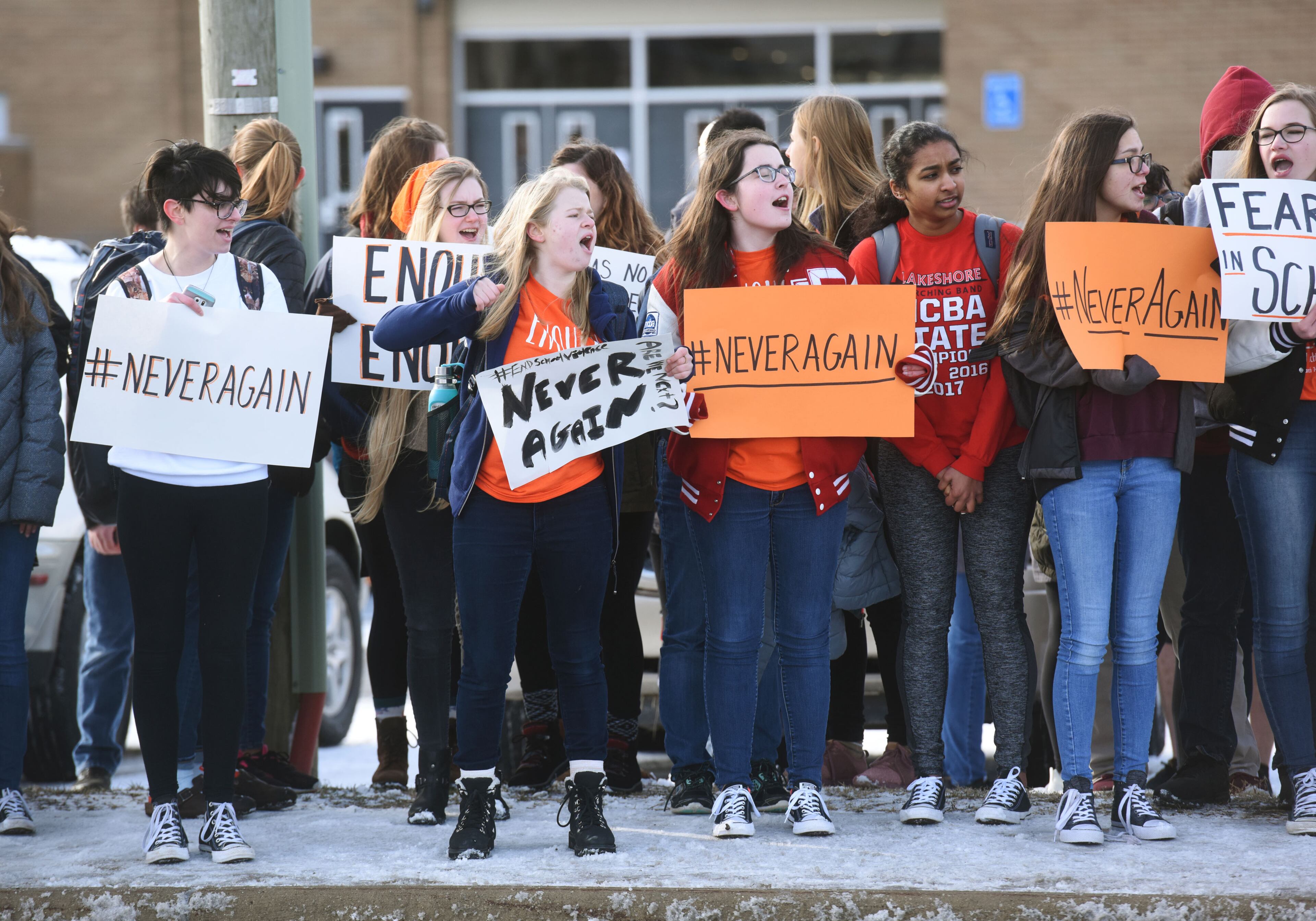 Students chant and hold signs as they participate in a walkout to protest gun violence, Wednesday, March 14, 2018, at Lakeshore High School in Stevensville, Mich., one month after the deadly shooting inside a high school in Parkland, Fla.