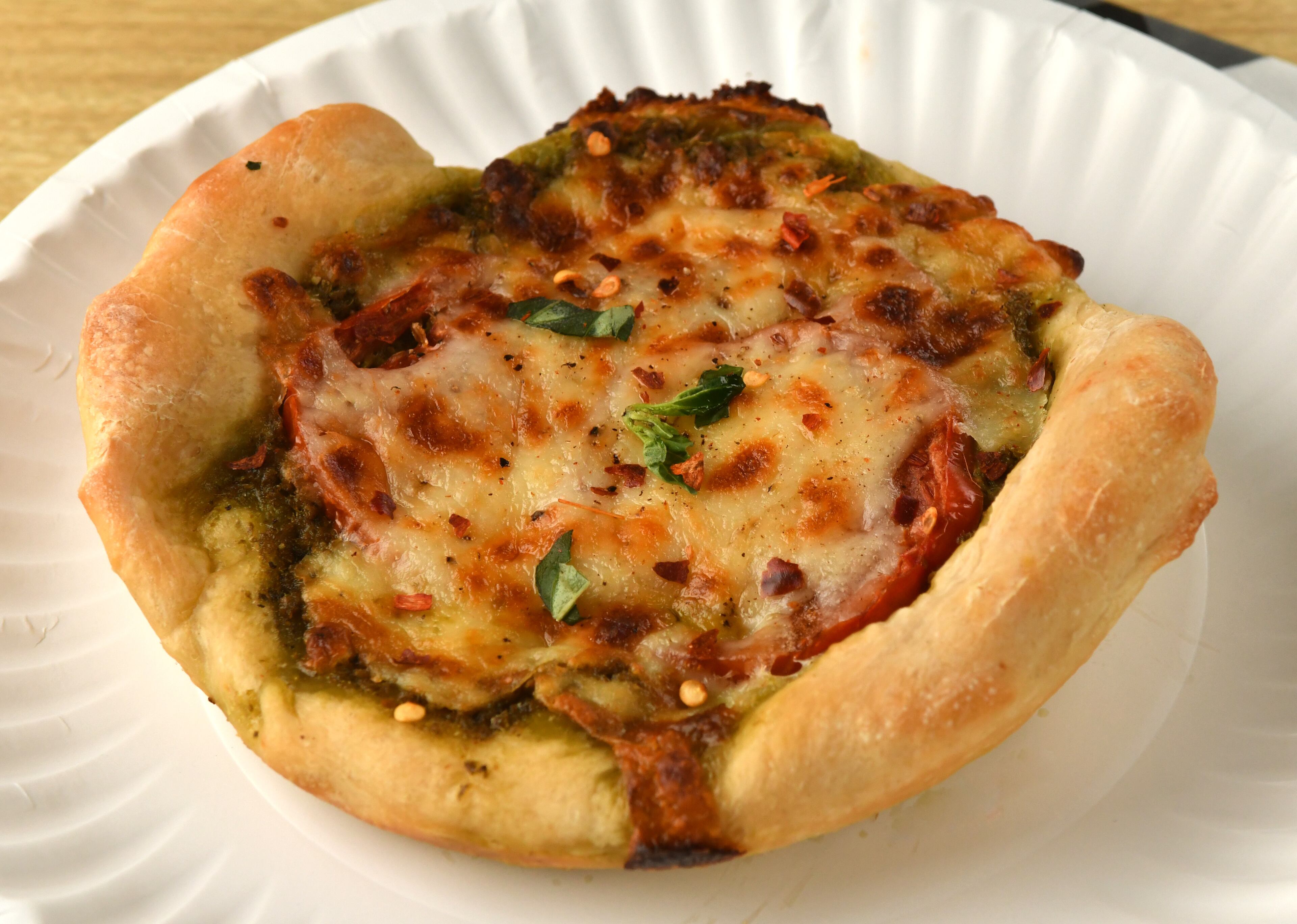 Pesto and Tomato Pizza can be made with homemade or high-quality store-bought pesto. (Styling by Susan Puckett / Chris Hunt for the AJC)