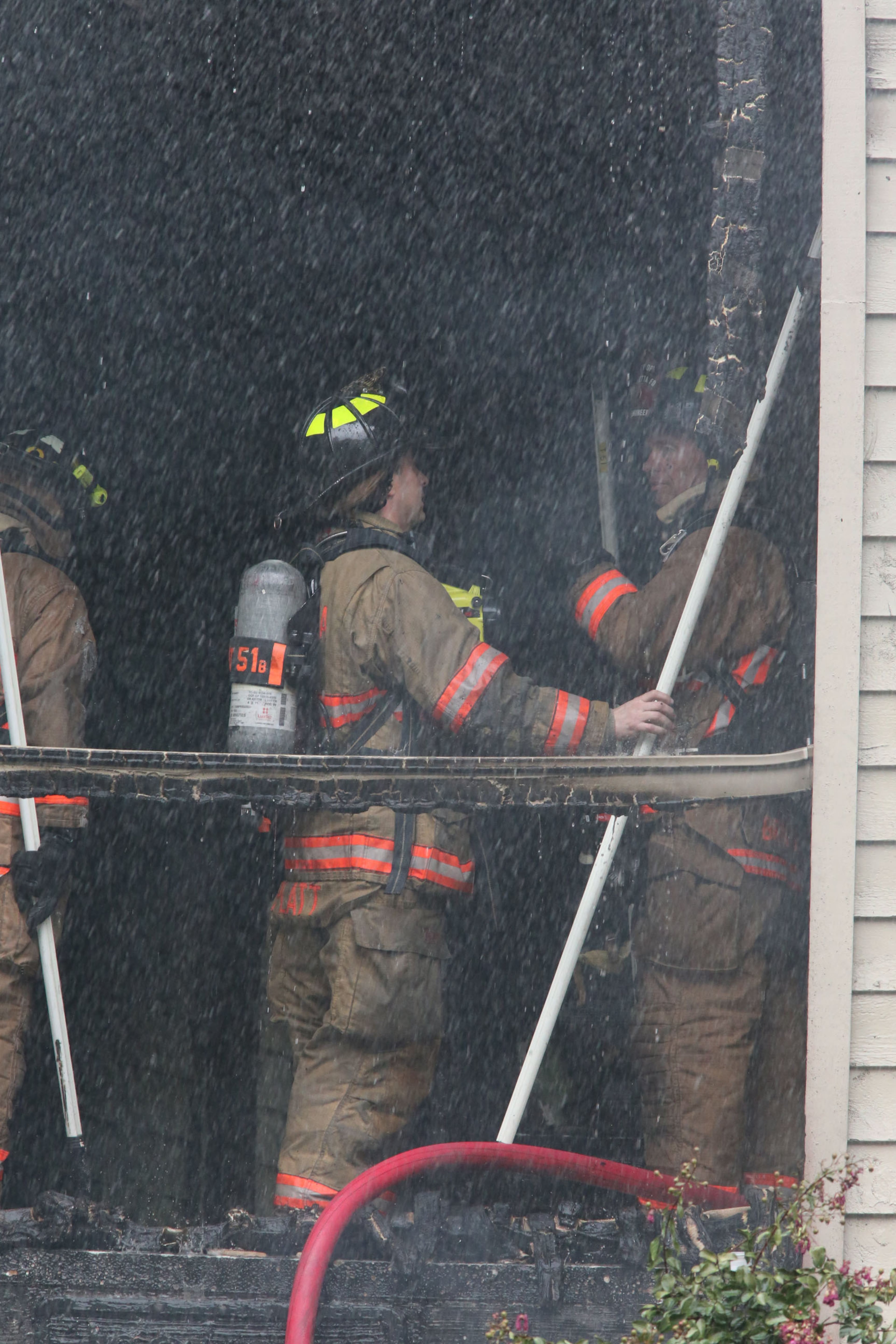 Cobb firefighters respond to a blaze at an apartment building on Powder Springs Road just south of Marietta on Friday, August 16, 2013.