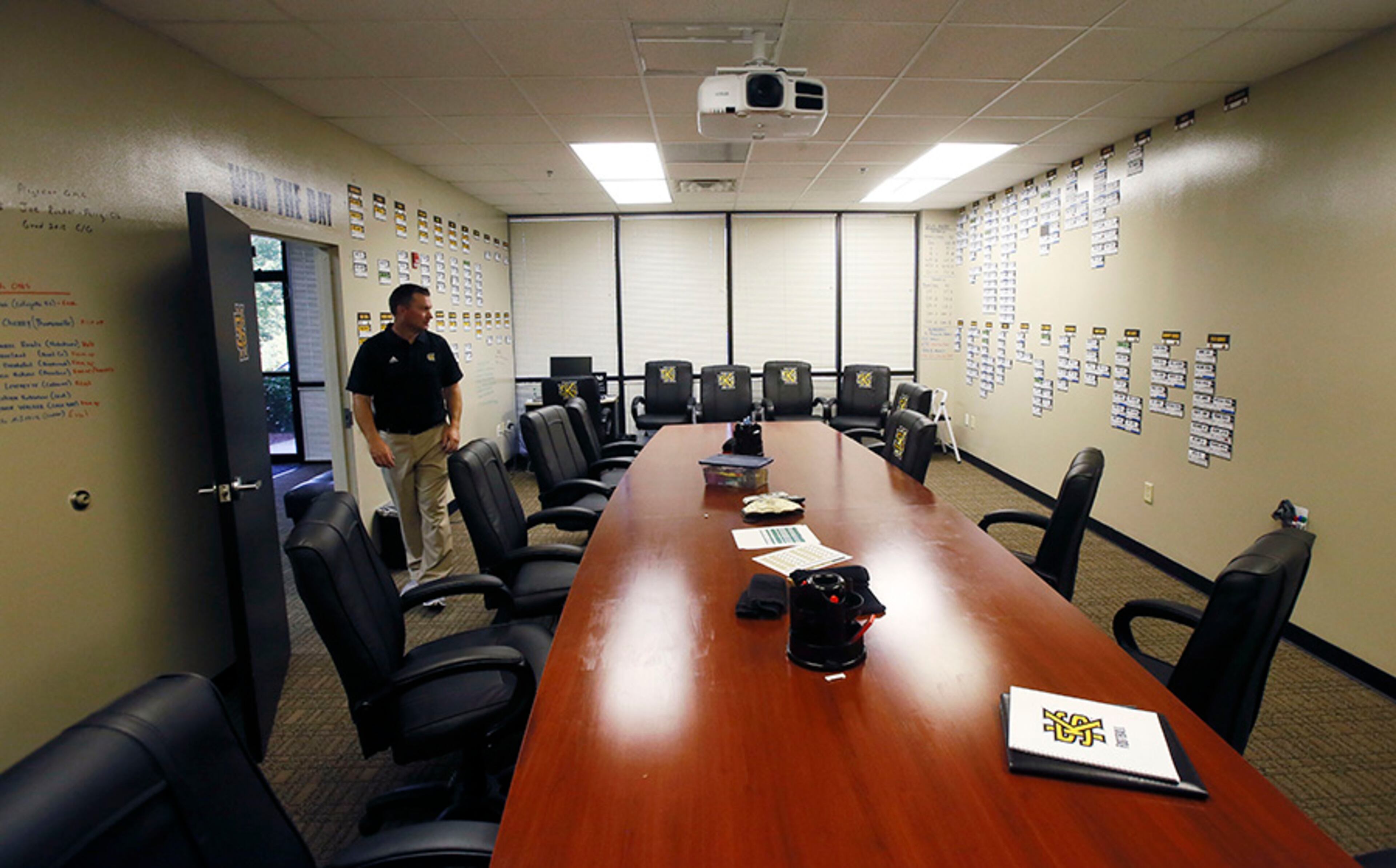 Head football coach Brian Bohannon walks through the team staff room at the football offices on the Kennesaw State campus.