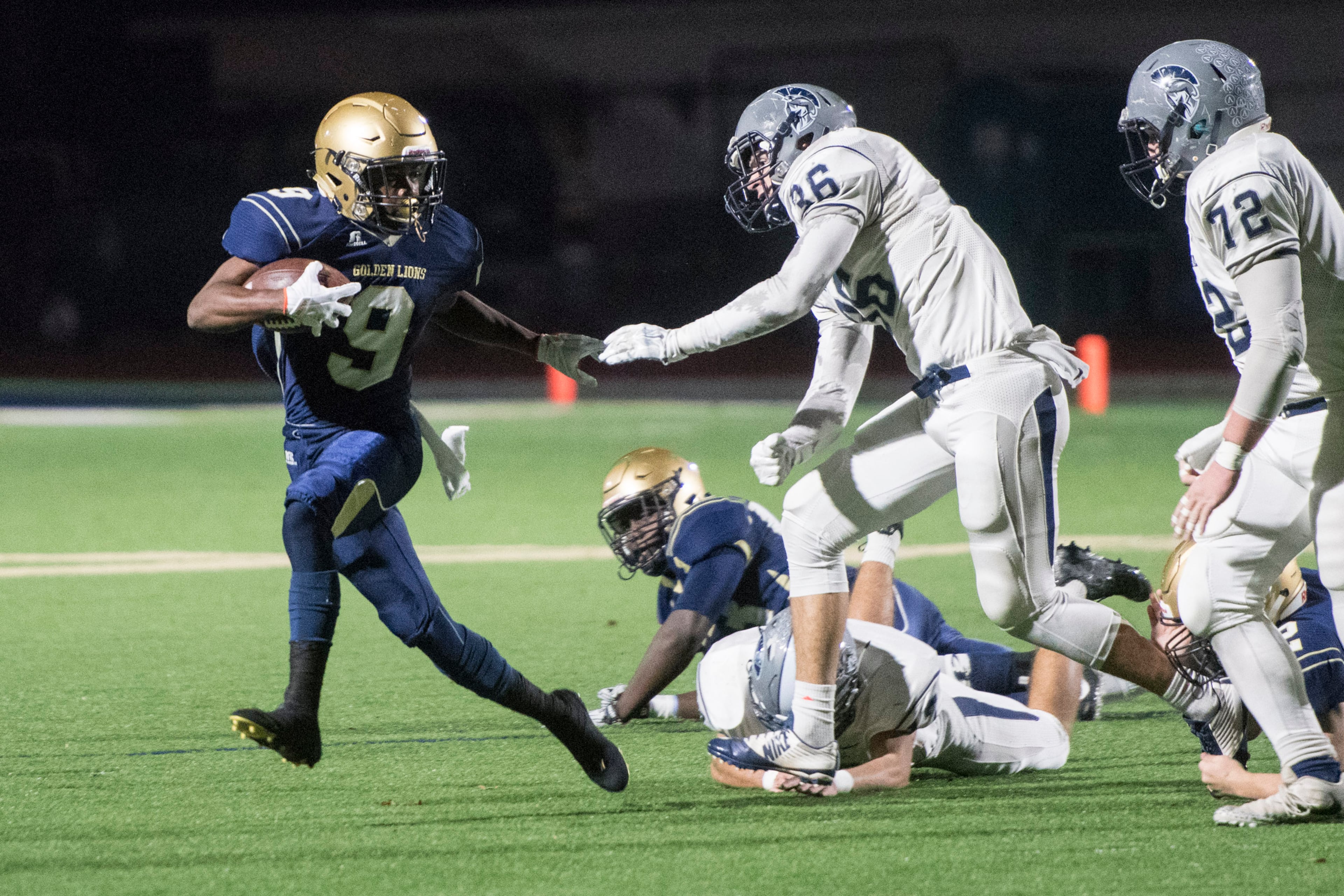 St Pius X RB Jason Jones (9) rushes against the defense of LB Austin Sinclair (36) and Tackle Damien Fouts (72) during the first round of state playoff football game, Friday, Nov. 10, 2017, in Chamblee. (John Amis)