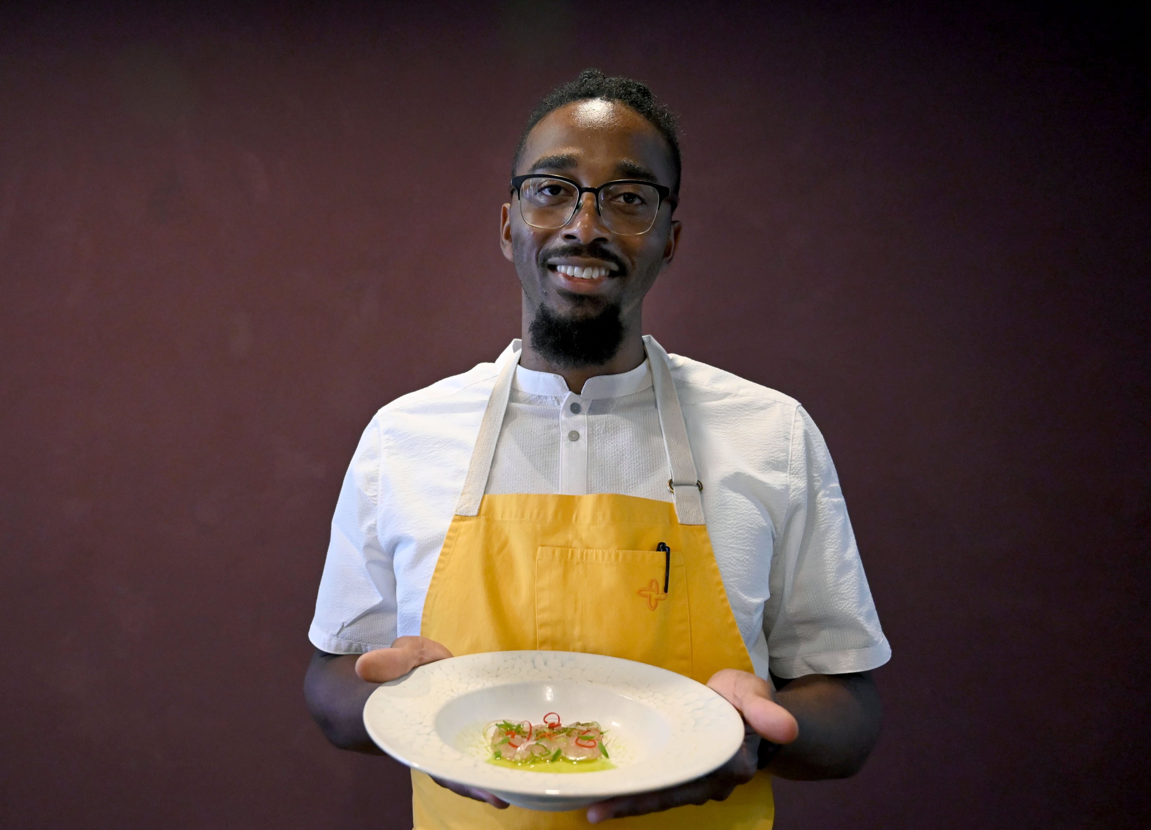 Chef Demetrius Brown holding his dish, Crudo from Haiti, poses for a portrait at Heritage Supper Club on Friday, Sept. 4, 2026, in Atlanta. Heritage, the highly anticipated new restaurant from Brown, is set to open Sept. 10. (Hyosub Shin/AJC)