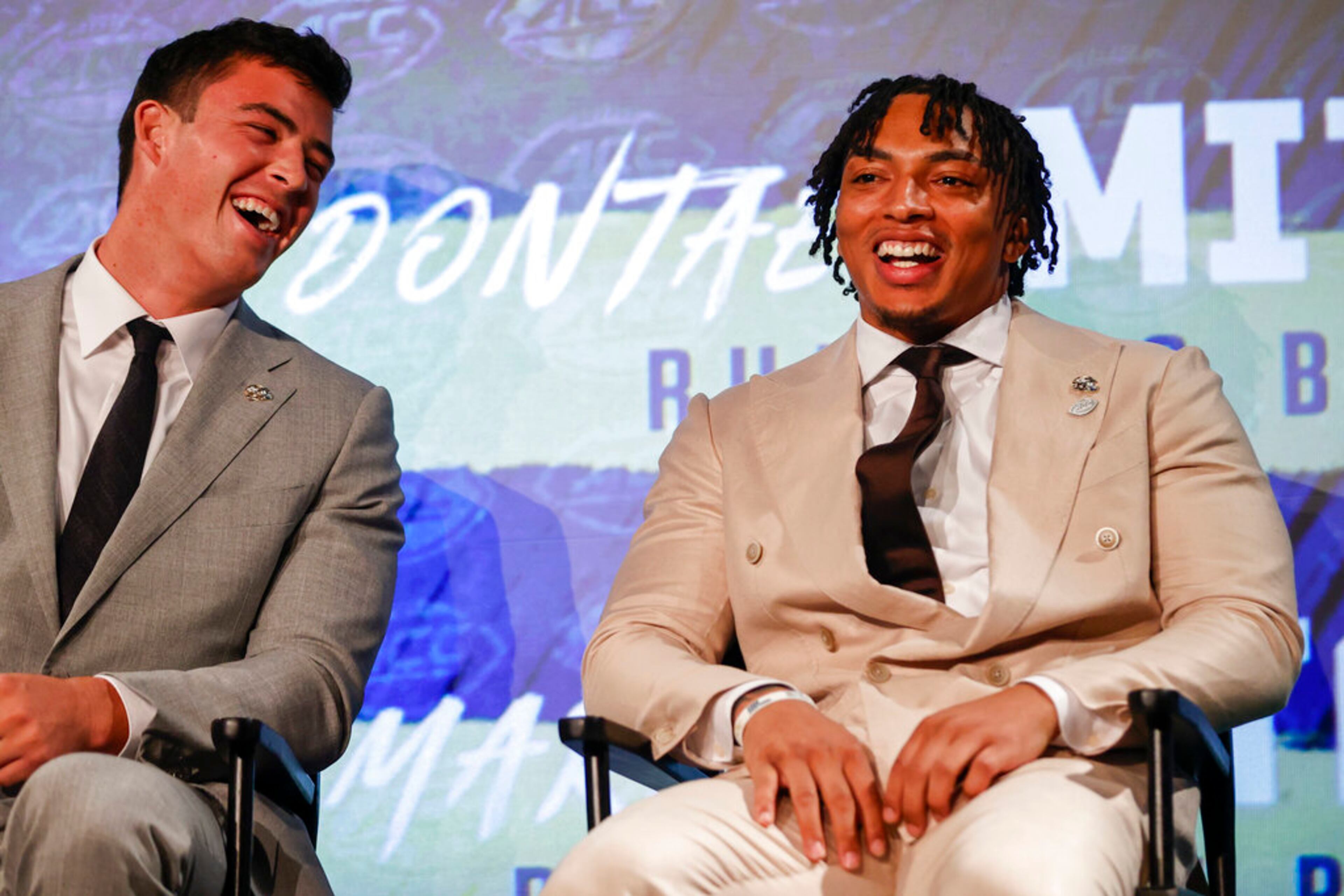 Georgia Tech running back Dontae Smith, right, and tight end Dylan Leonard laugh as the sit on stage at the NCAA college football Atlantic Coast Conference Media Days in Charlotte, N.C., Thursday, July 21, 2022. (AP Photo/Nell Redmond)