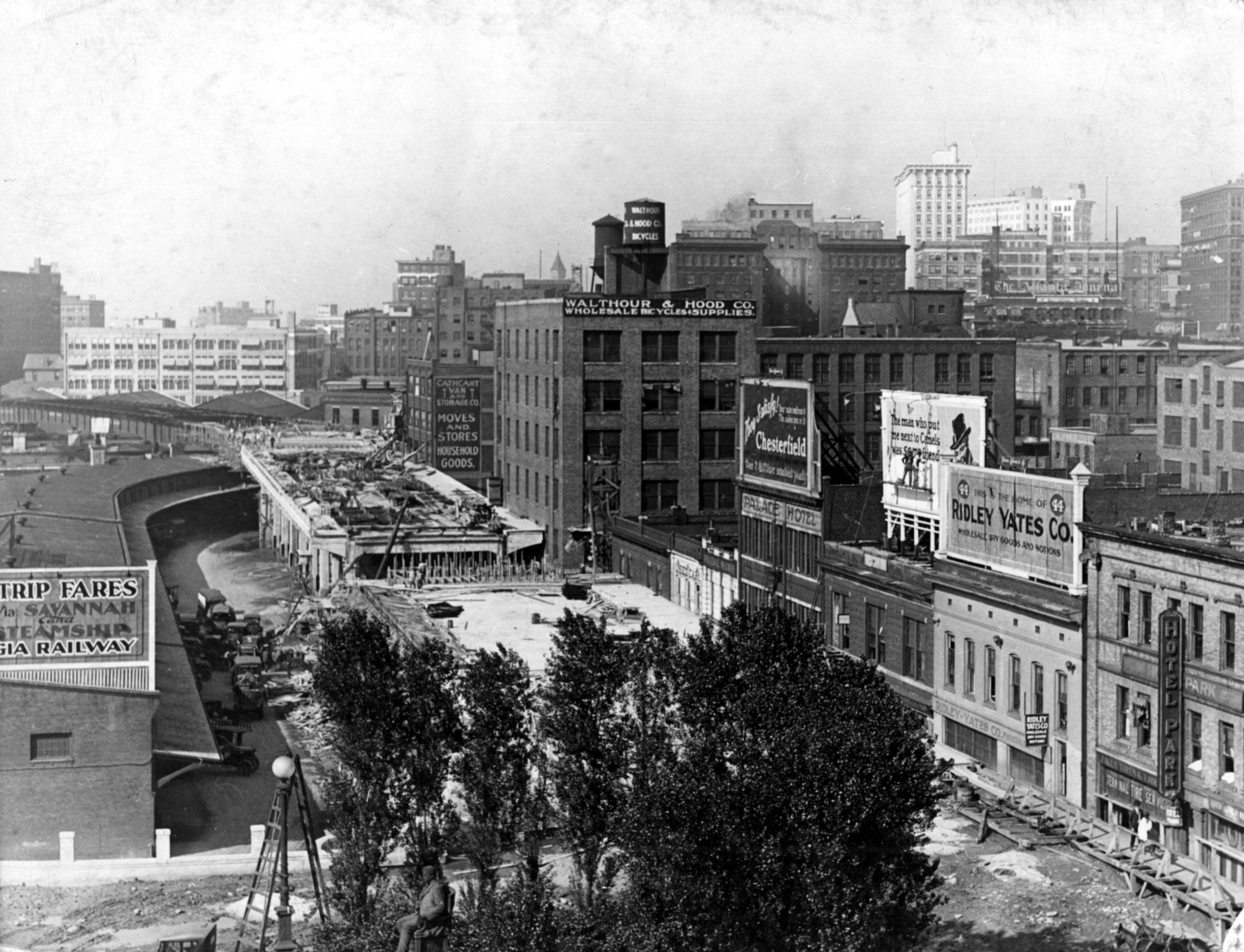 Construction of the Spring Street viaduct sometime around 1920. Buildings on Madison Street (right) include the Hotel Park, Ridley Yates Co., the Palace Hotel and Cathcart Moves and Stores. The Walthour & Hood Co. was at the intersection of West Hunter Street and Madison Ave. The tall white building in the far right background is the Candler Building. (File)