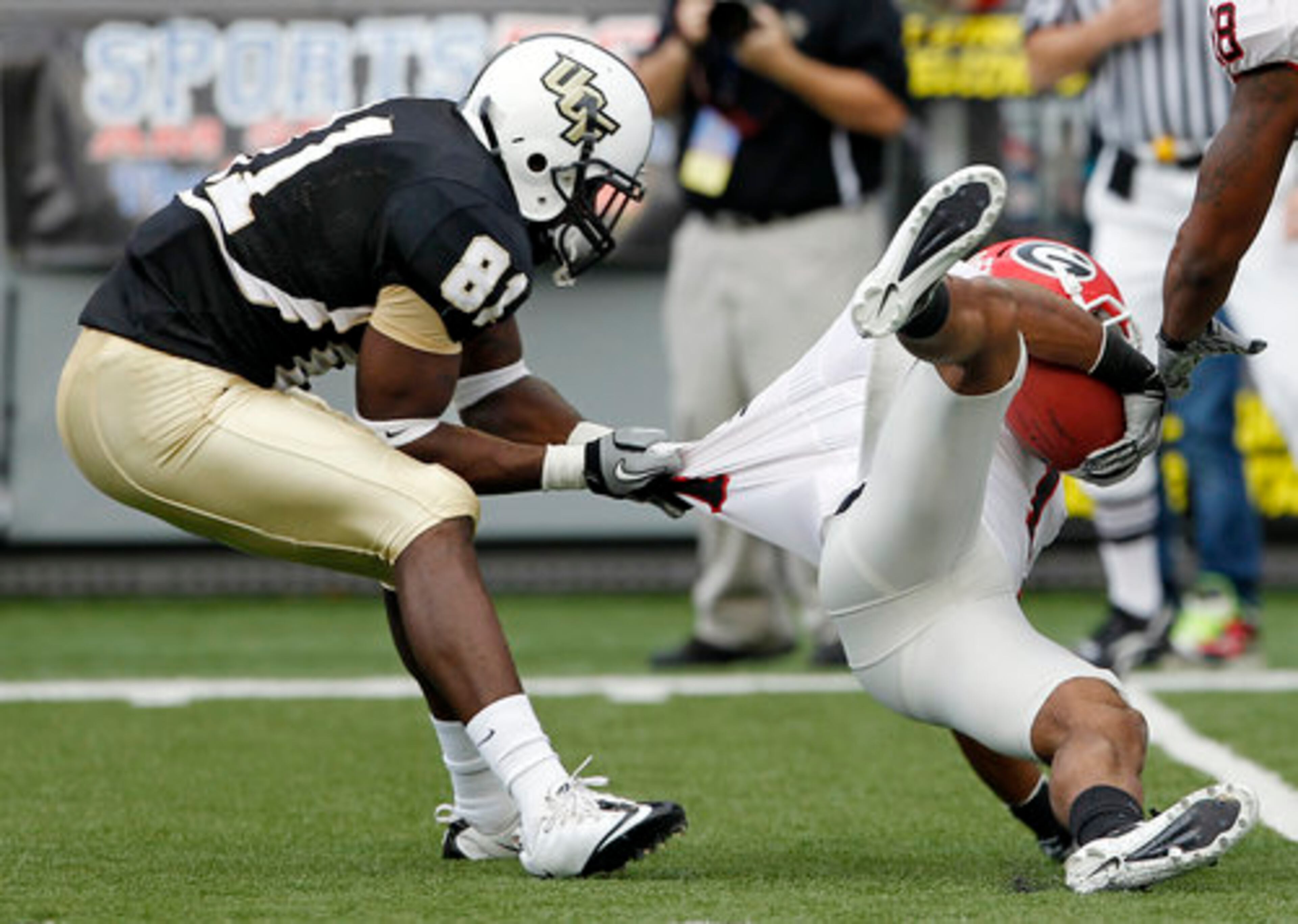 Central Florida wide receiver Kamar Aiken (81) brings down Georgia cornerback Branden Smith after Smith intercepted a pass in the first quarter of the Liberty Bowl NCAA college football game on Friday, Dec. 31, 2010 in Memphis, Tenn.