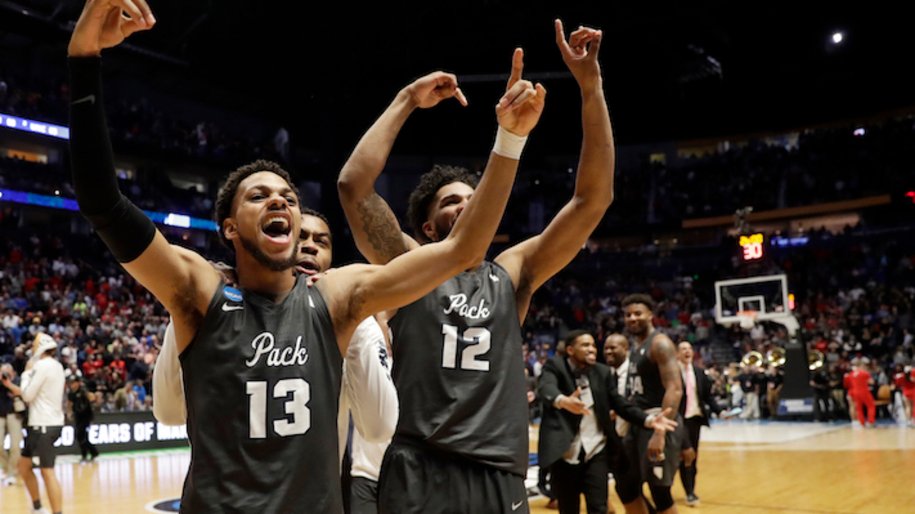 Nevada guard Hallice Cooke (13) and forward Elijah Foster (12) celebrate at the end end of the second half of a second-round game against Cincinnati, in the NCAA college basketball tournament in Nashville, Tenn., Sunday, March 18, 2018. Nevada defeated Cincinnati 75-73. (AP Photo/Mark Humphrey)