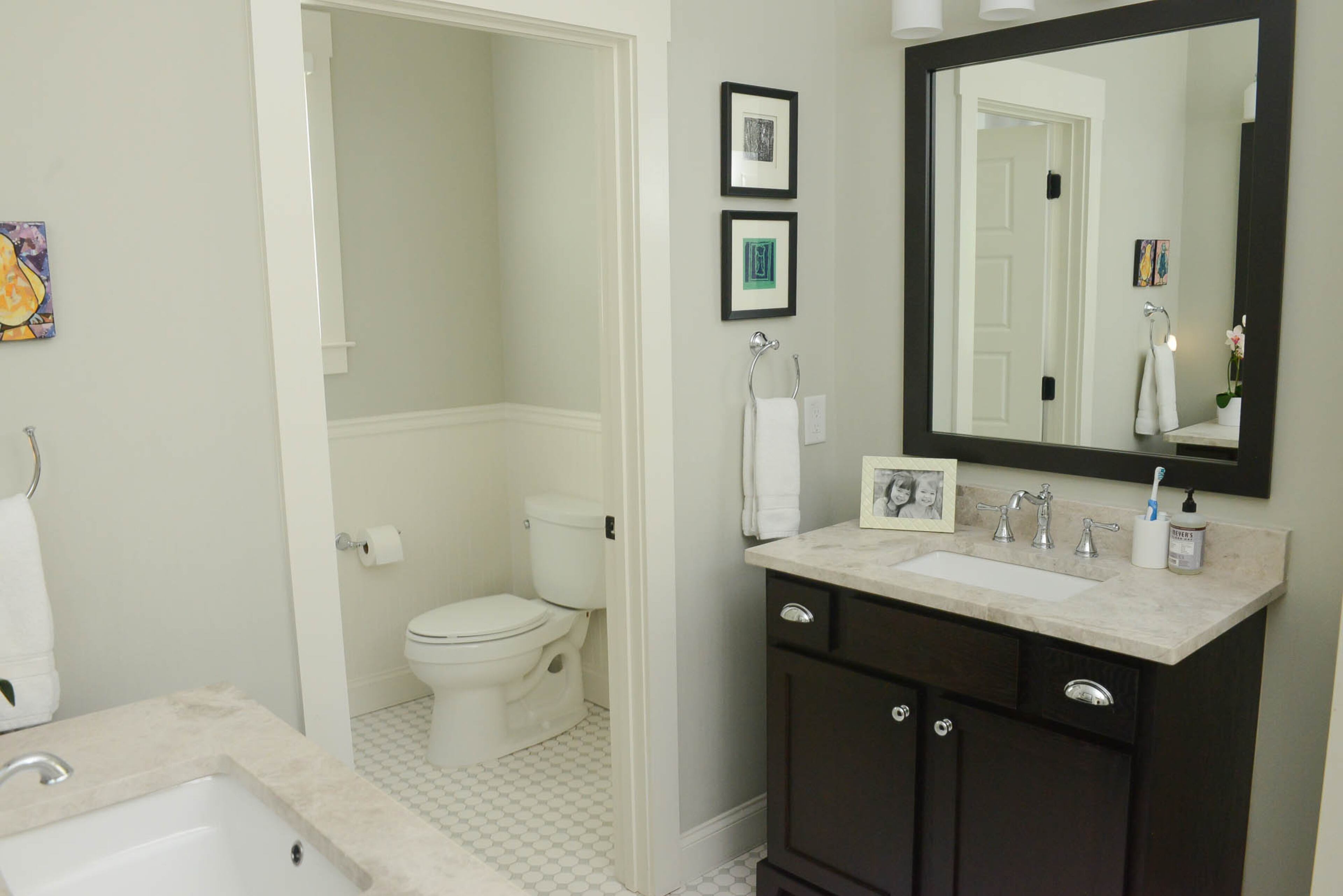 A Jack-and-Jill bathroom links Jane and Avery Breslin’s bedrooms. Framed pictures of the girls and their art adorns the bathroom. “Each year, with our daughters’ help, we select one of each of their masterpieces and have it nicely framed, which makes all the difference,” said their mom.
