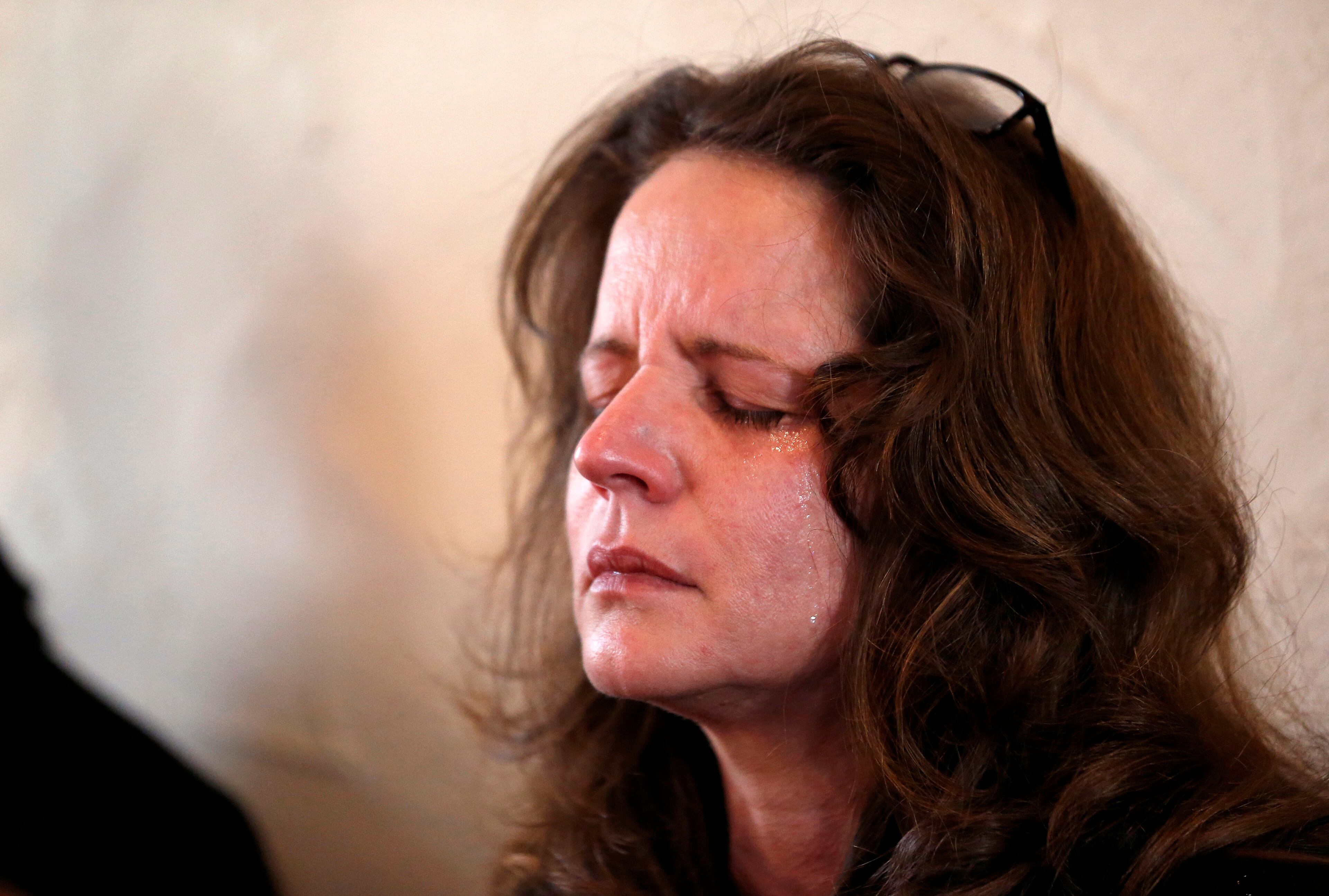 Catherine Purcell, of Mansfield, Mass., reacts during a service in honor of the victims who died a day earlier when a gunman opened fire at Sandy Hook Elementary School in Newtown, Conn., as people gathered at St. John's Episcopal Church , Saturday, Dec. 15, 2012, in the Sandy Hook village of Newtown, Conn. The massacre of 26 children and adults at Sandy Hook Elementary school elicited horror and soul-searching around the world even as it raised more basic questions about why the gunman, 20-year-old Adam Lanza, would have been driven to such a crime and how he chose his victims. (AP Photo/Julio Cortez)