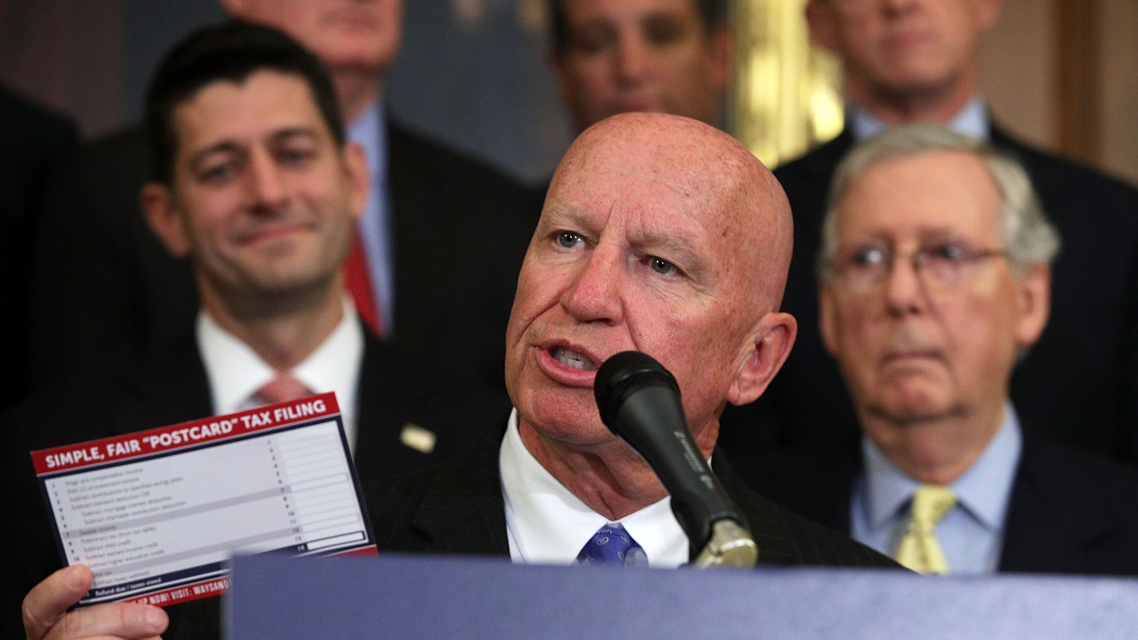 Rep. Kevin Brady holds up a tax filing "postcard" during a press event on tax reform on Sept. 27, 2017, at the U.S. Capitol.
