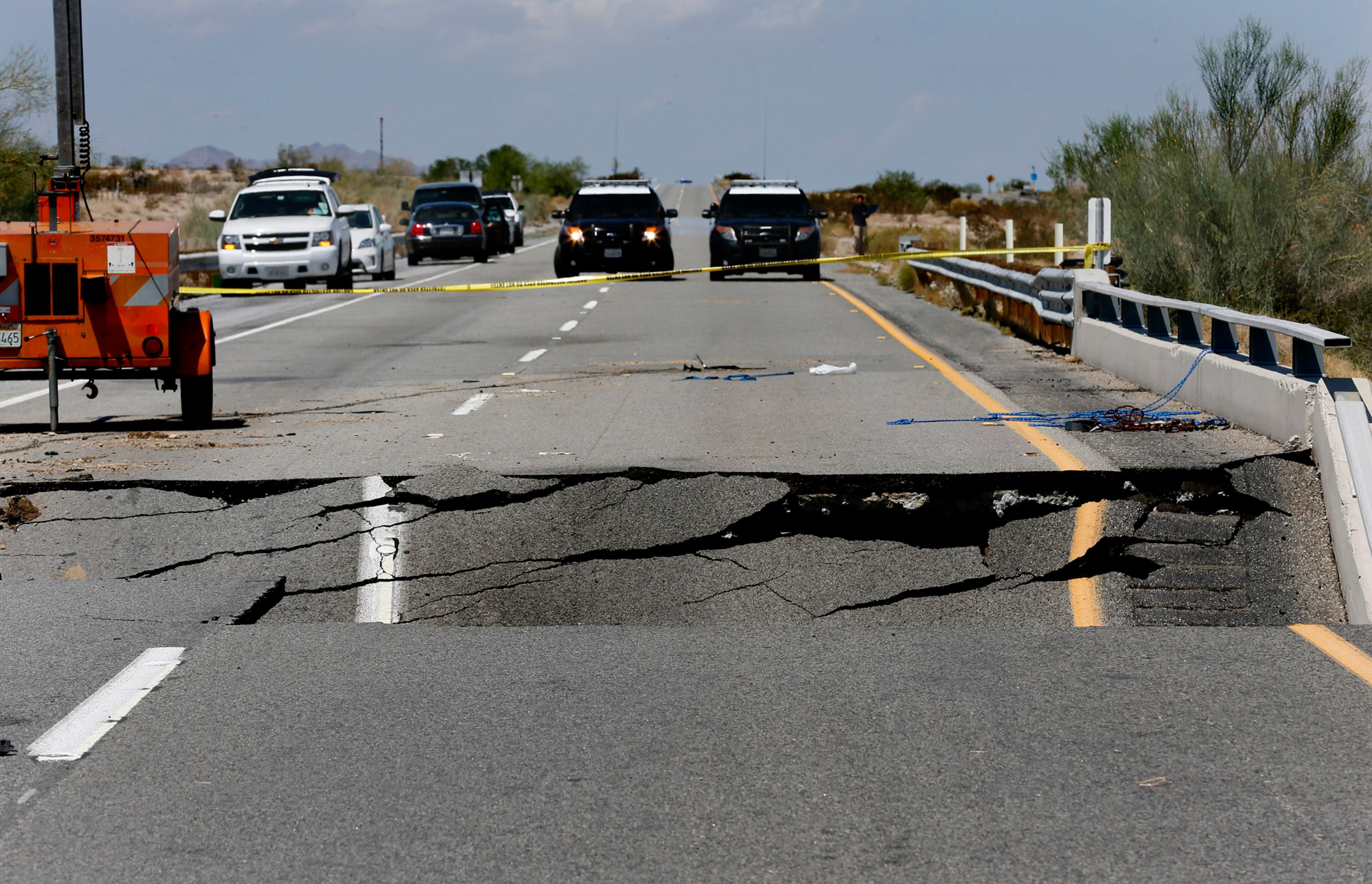 California Highway Patrol vehicles block a section of Interstate 10 between Coachella, Calif., and the Arizona border where Sunday's flash floods washed out a bridge over a desert wash. (Don Bartletti/Los Angeles Times/TNS)