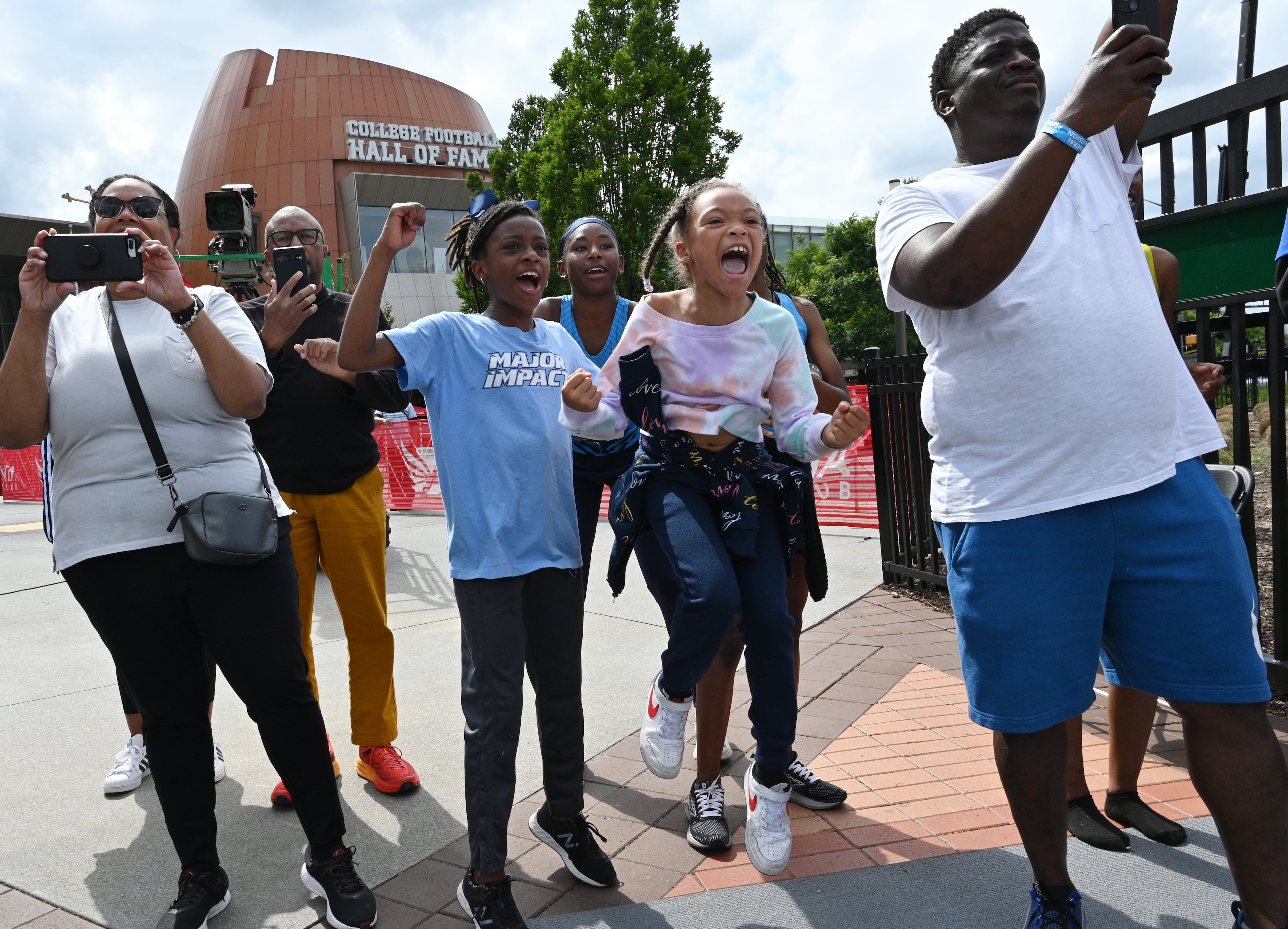 Family members, friends and fans cheer as youth athletes compete the 150 during the adidas Atlanta Youth City Games at Centennial Olympic Park, Saturday, May 6, 2023, in Atlanta. (Hyosub Shin / Hyosub.Shin@ajc.com)