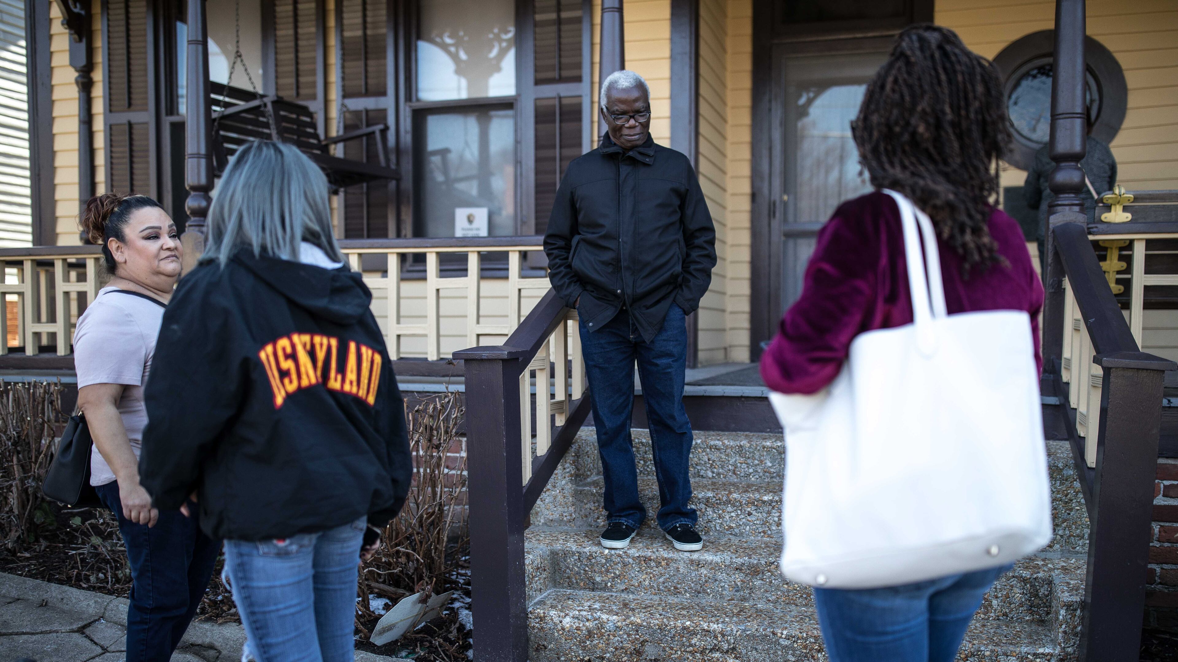 James Edigin (center) poses Saturday for a photo in front of the Rev. Martin Luther King Jr.'s childhood home shortly after a park ranger closed that part of the national historic site as a result of the government shutdown. The shutdown and its effect on national parks and other federal services continued into Sunday.