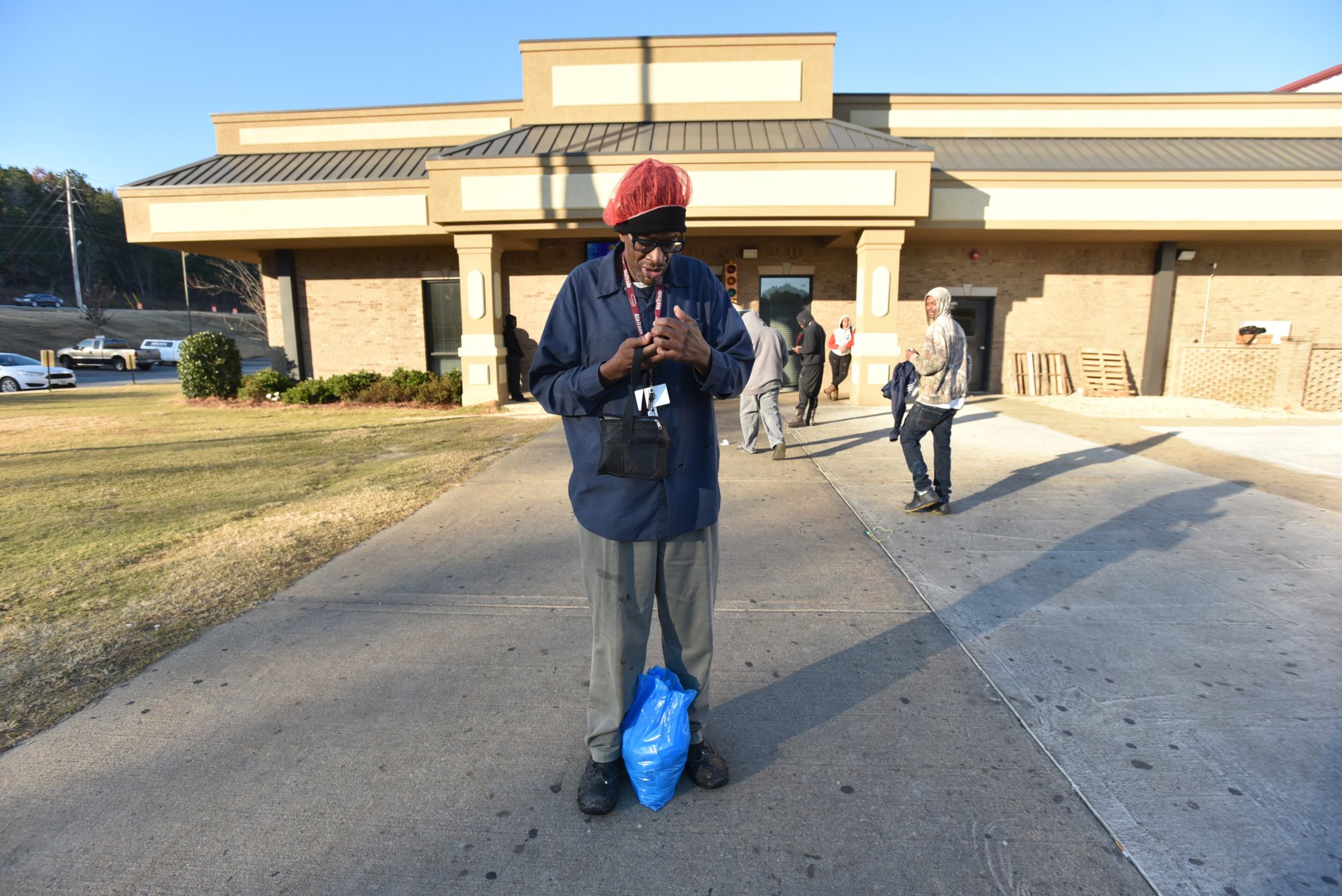 Byron Ferguson waits for a ride outside Alatrade Foods in Phoenix City, Ala.