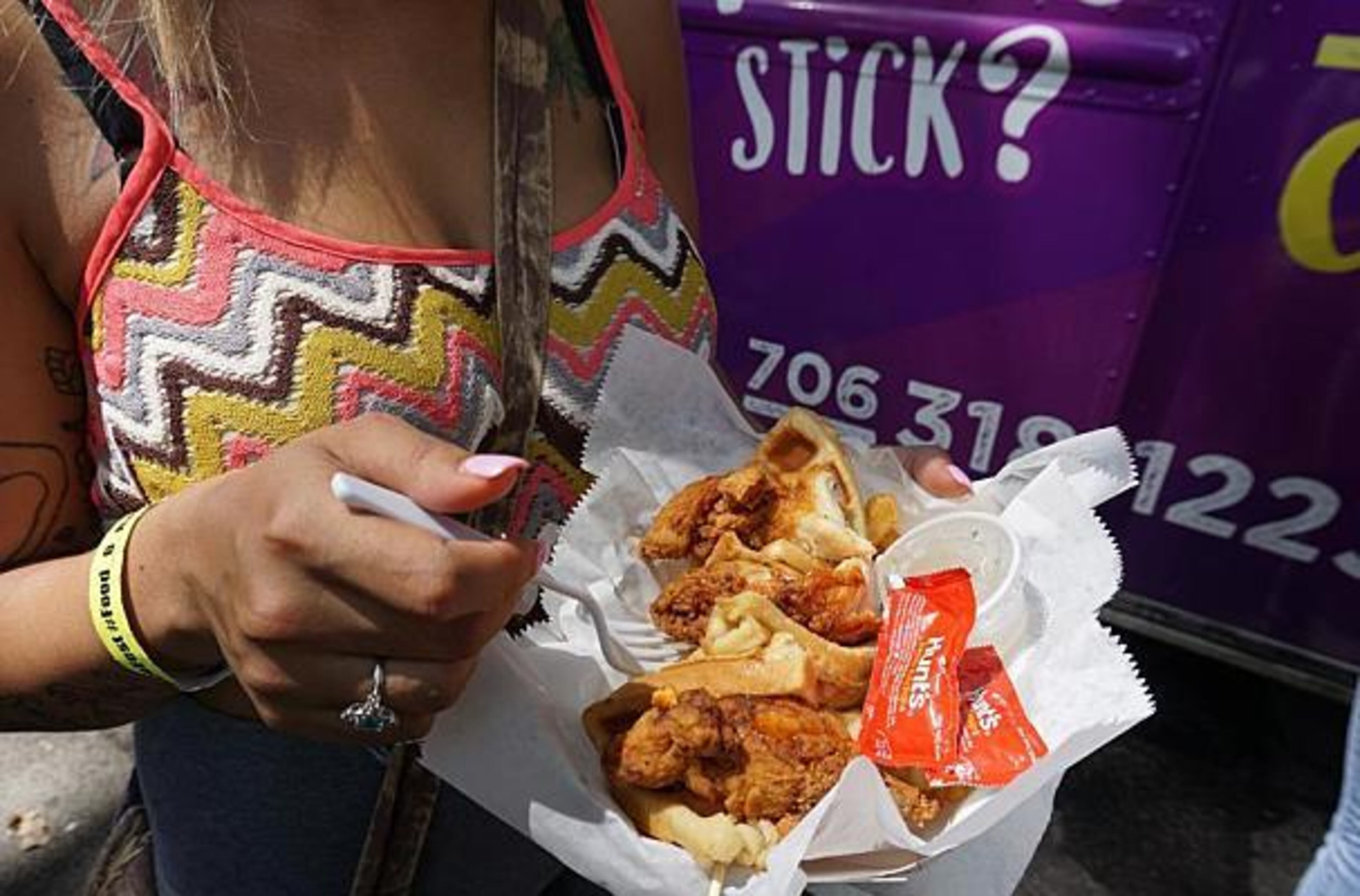 An Atlanta Margarita and Taco Festival attendee shows off her speciality waffle and chicken tacos.
