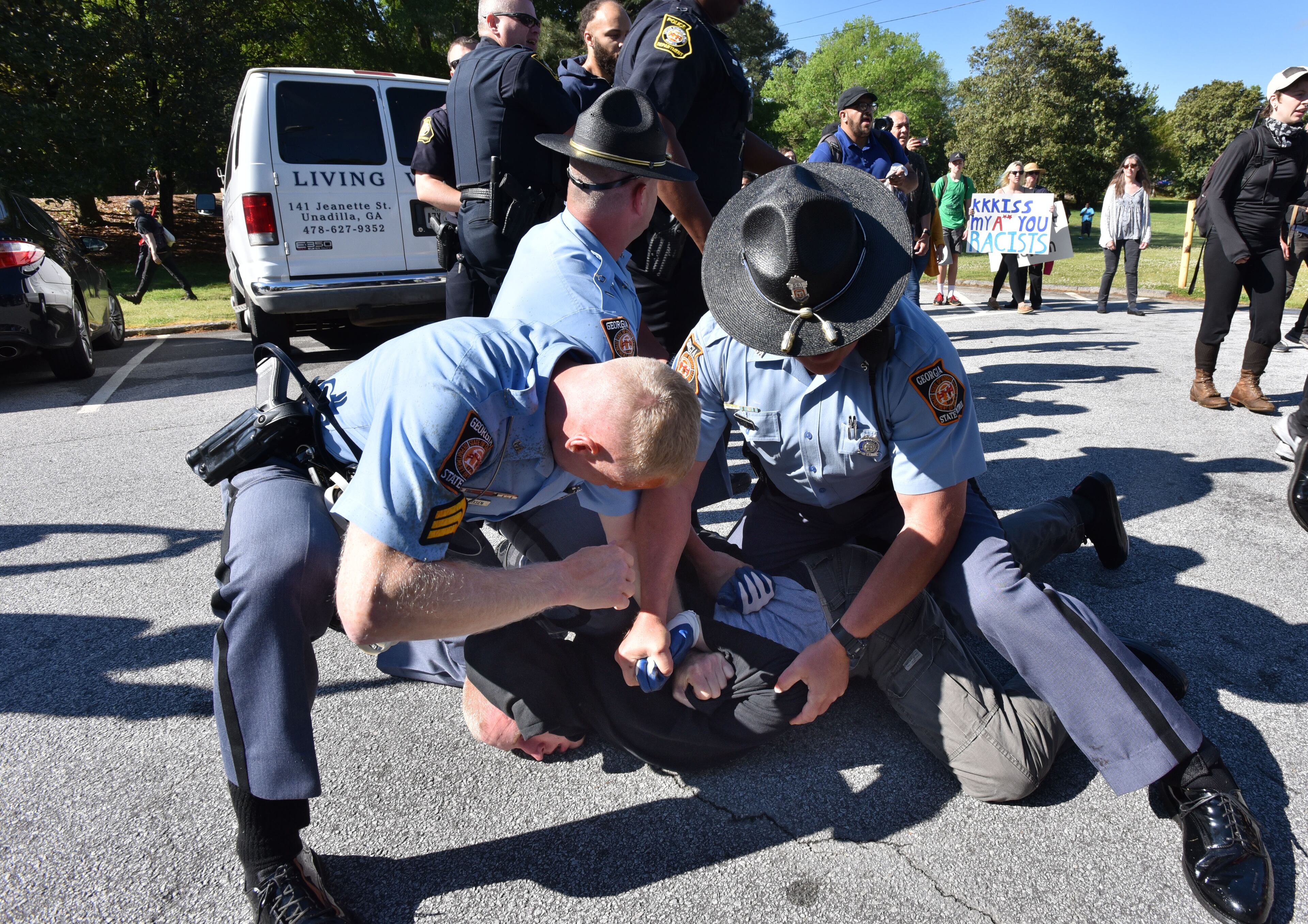 A counter-protester is arrested by police as they try to get past police and to a white power protest at Stone Mountain Park on Saturday, April 23, 2016.