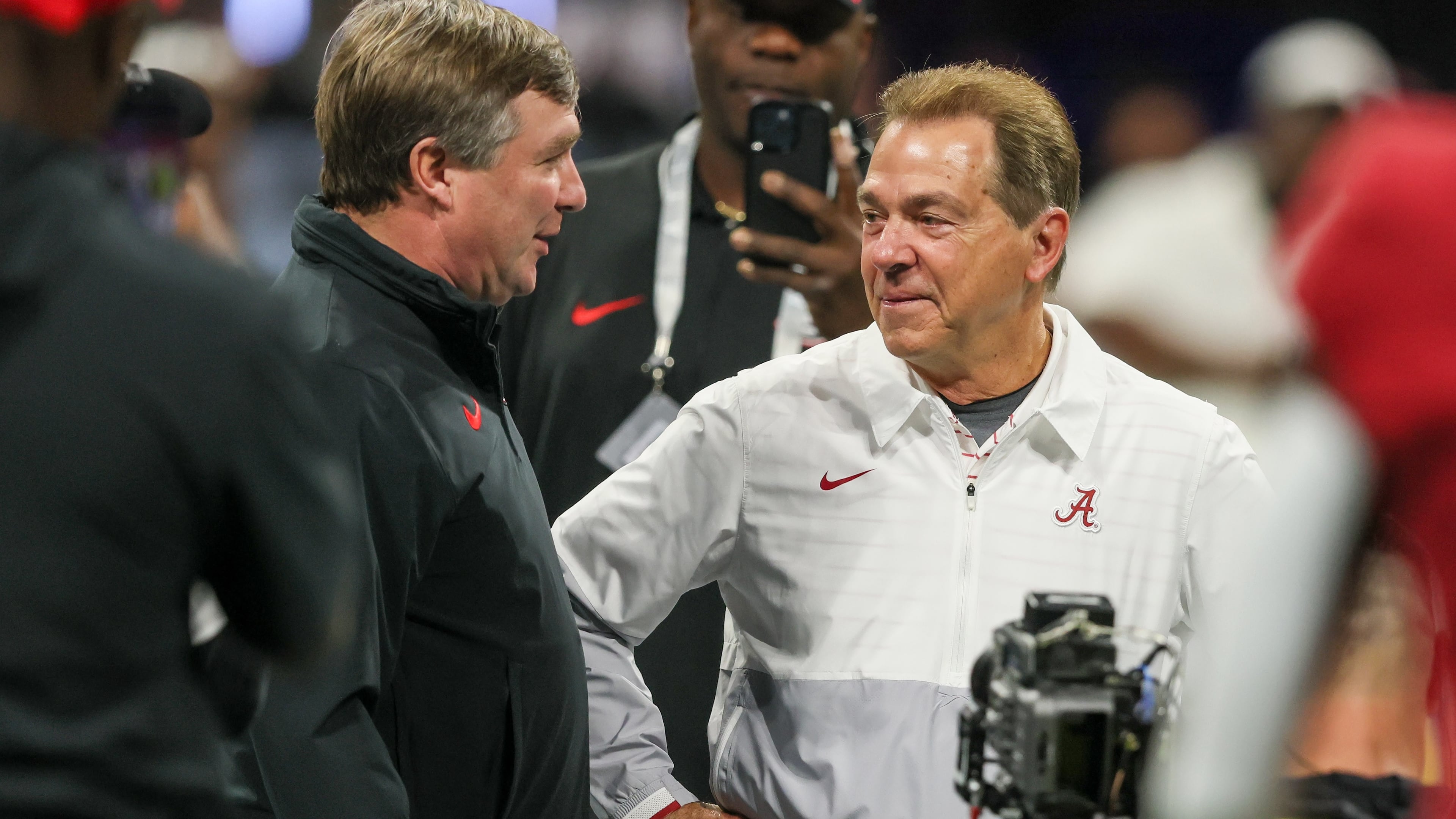 Former Alabama coach Nick Saban (right) — pictured with Georgia coach Kirby Smart before the 2023 SEC championship game — has been retired for more than two years, but he has continued to comment on college football and influence the game through his work on ESPN’s “College GameDay.” (Jason Getz/AJC)