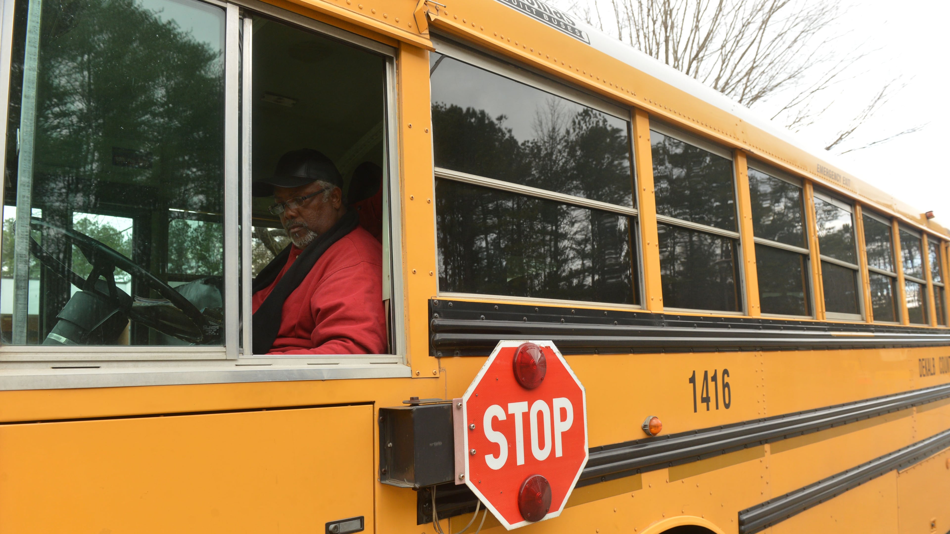 Bus driver David Warner of Newnan worked as students came out for dismissal at Woodridge Elementary School in Stone Mountain on Jan. 21, 2014. KENT D. JOHNSON/KDJOHNSON@AJC.COM