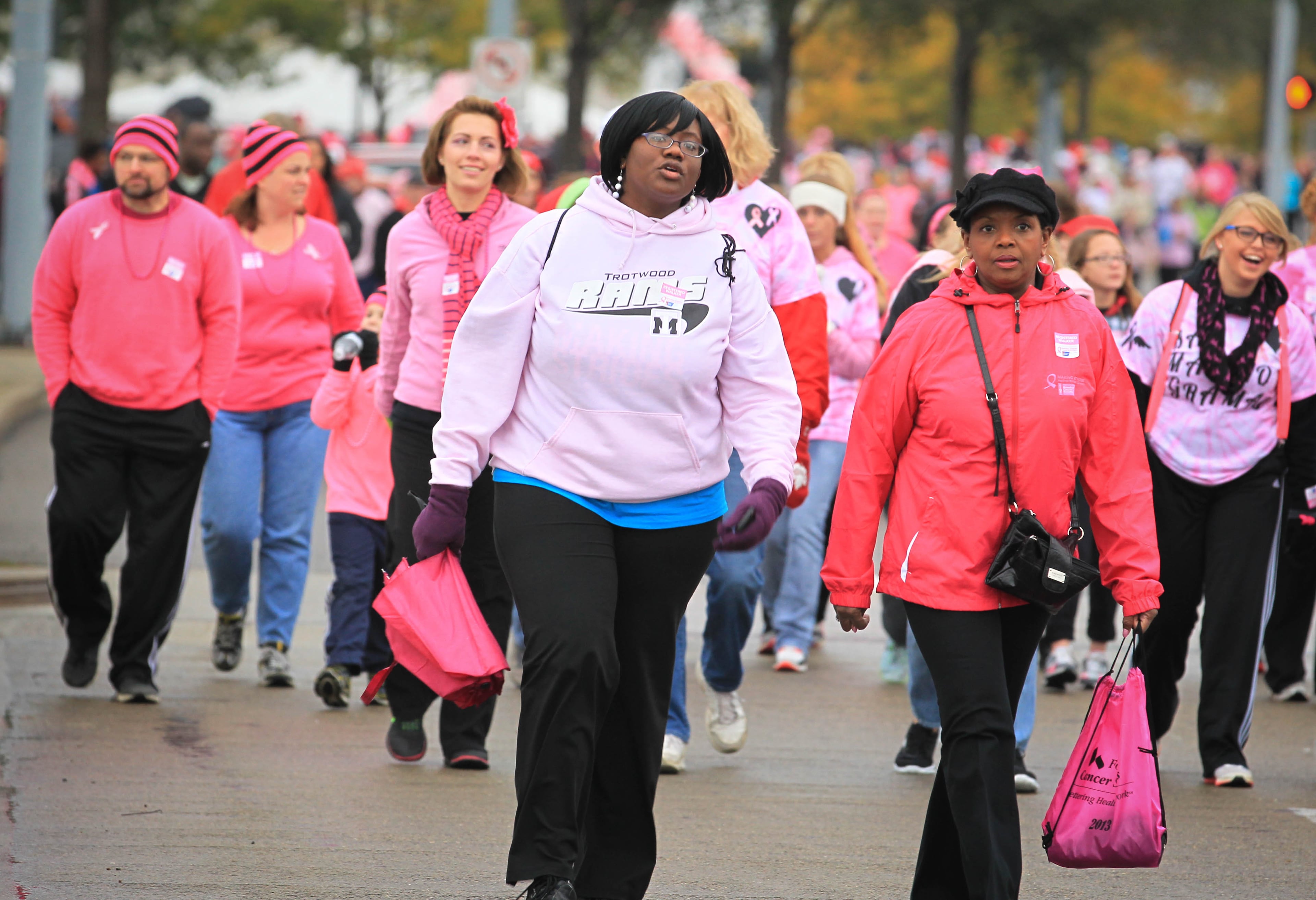 Participants at the Making Strides Against Breast Cancer Walk in Dayton at Fifth Third Field trek along the route Saturday morning. JIM WITMER / STAFF