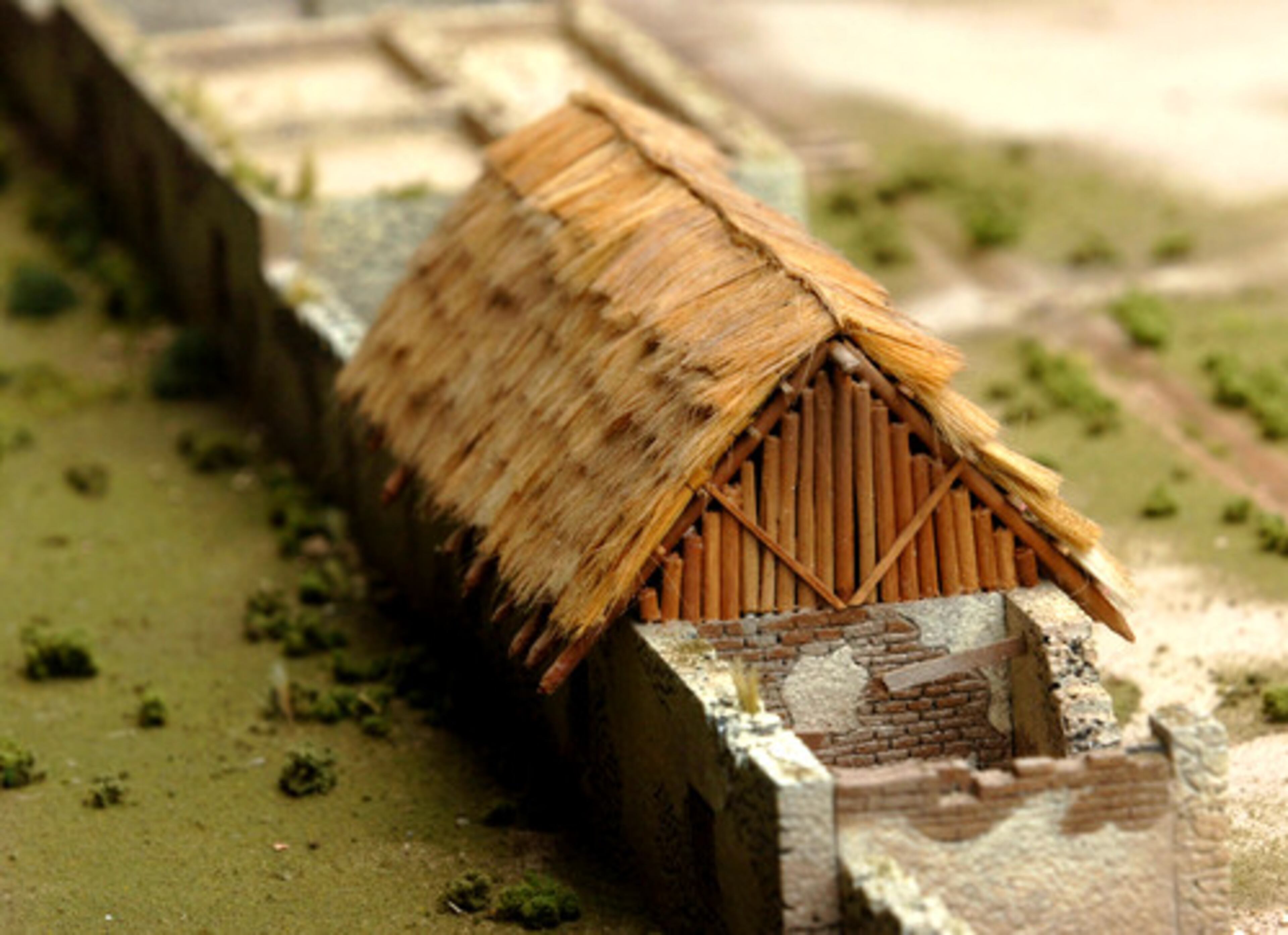 He used high density foam board to construct his three-dimensional model. Materials included scenic modeling clay for mounded earth, balsa wood for planking on gun ramps and twigs and sticks for logs on the palisades.