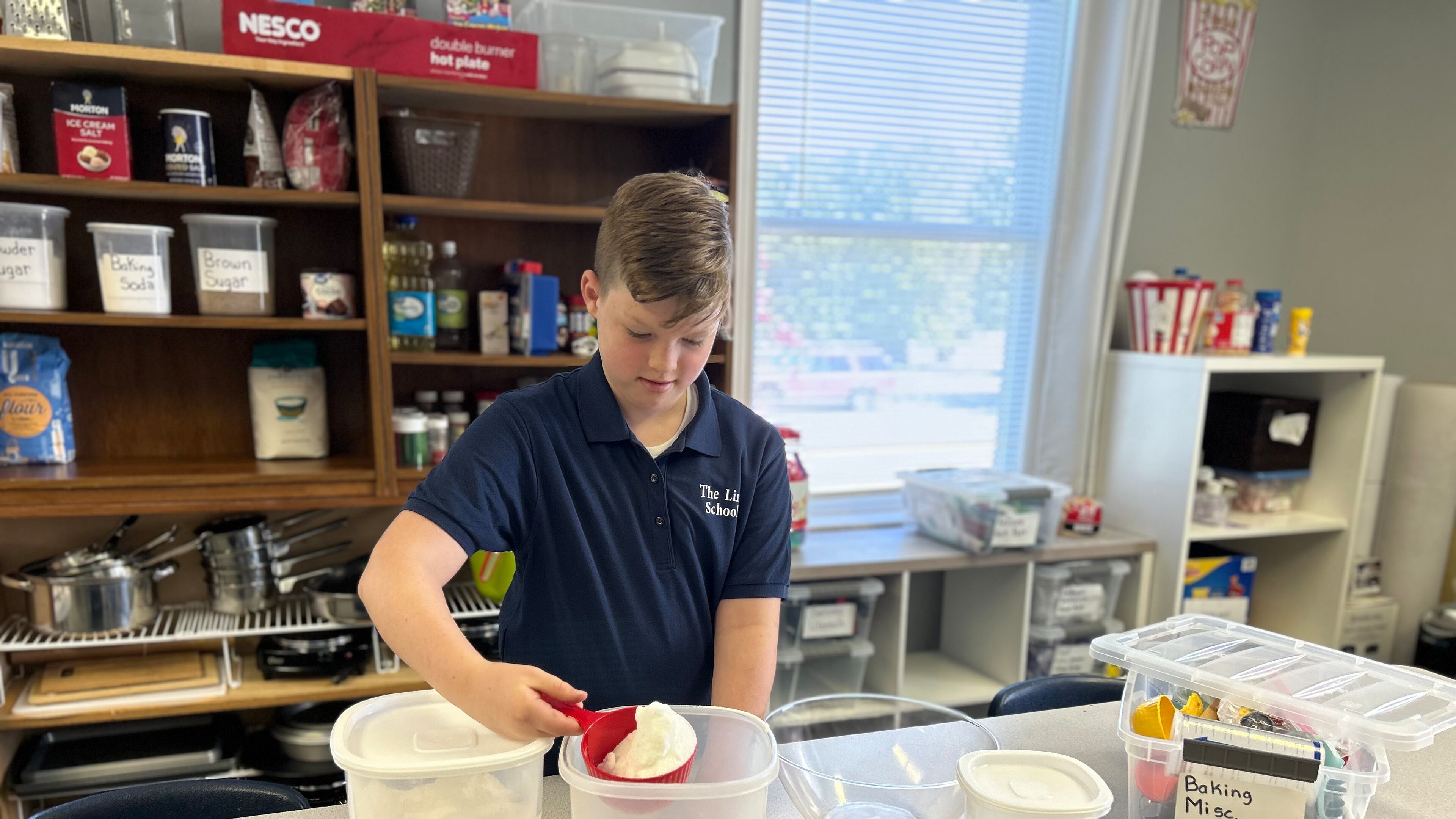 Student Ben Herbert measures ingredients for a cake as part of The Link School's life skills class.