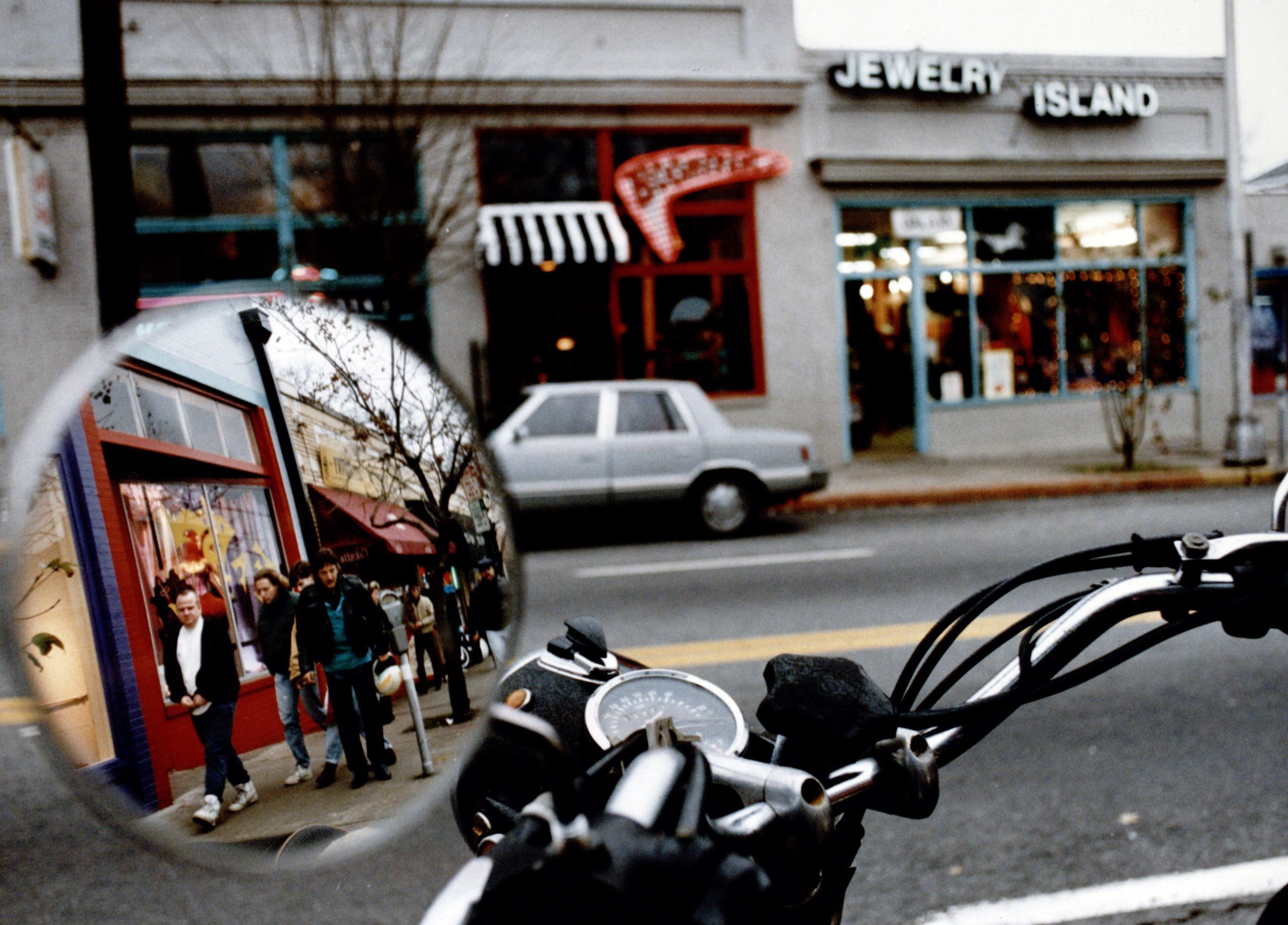 Reflections of Little Five Points shoppers in a bike mirror, January 14, 1993.
