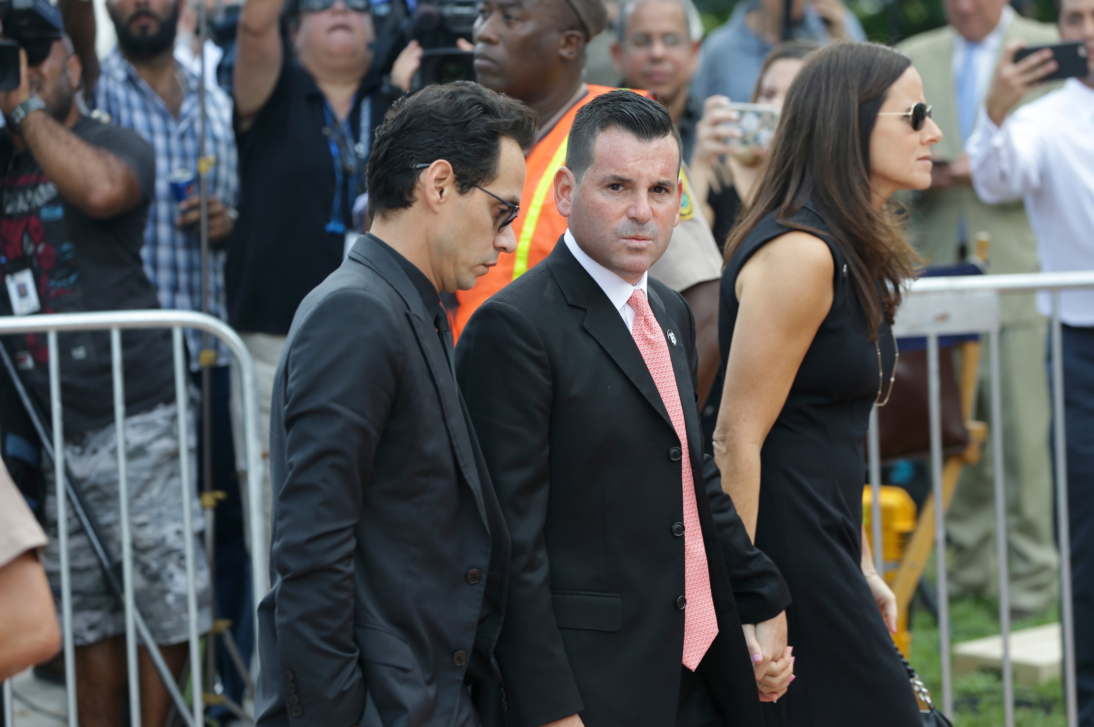 Miami Marlins president David Samson, center, and musician Marc Anthony, left, arrive for a memorial service for Miami Marlins pitcher Jose Fernandez, at St. Brendan's Catholic Church, Thursday, Sept. 29, 2016, in Miami. Fernandez was killed in a boating accident Sunday along with two friends. (AP Photo/Lynne Sladky)