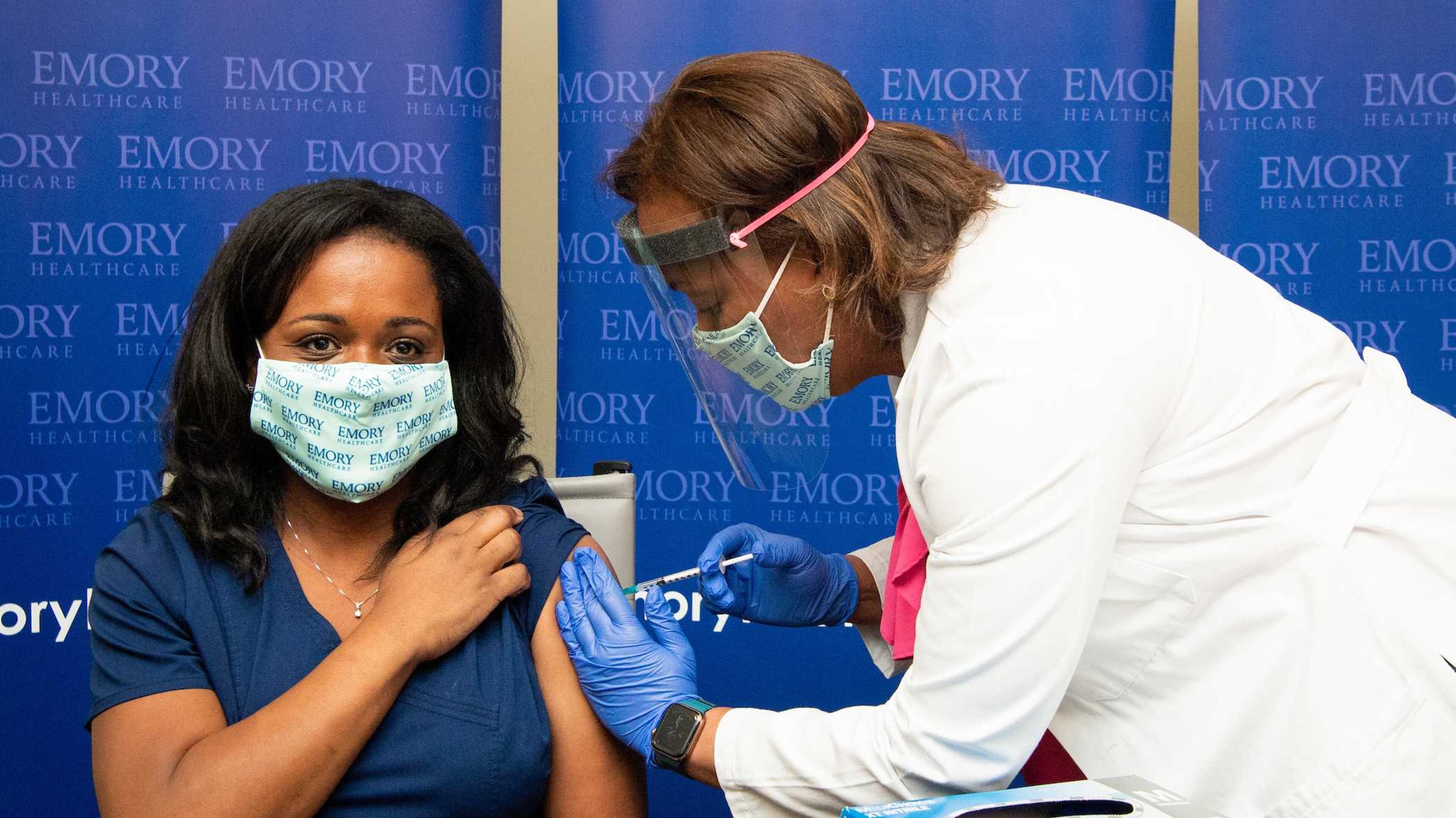 Nicole Baker, left, an emergency room nurse and manager at Emory University Hospital, was the first employee to receive the Pfizer-BioNTech vaccination at Emory last December. CONTRIBUTED.